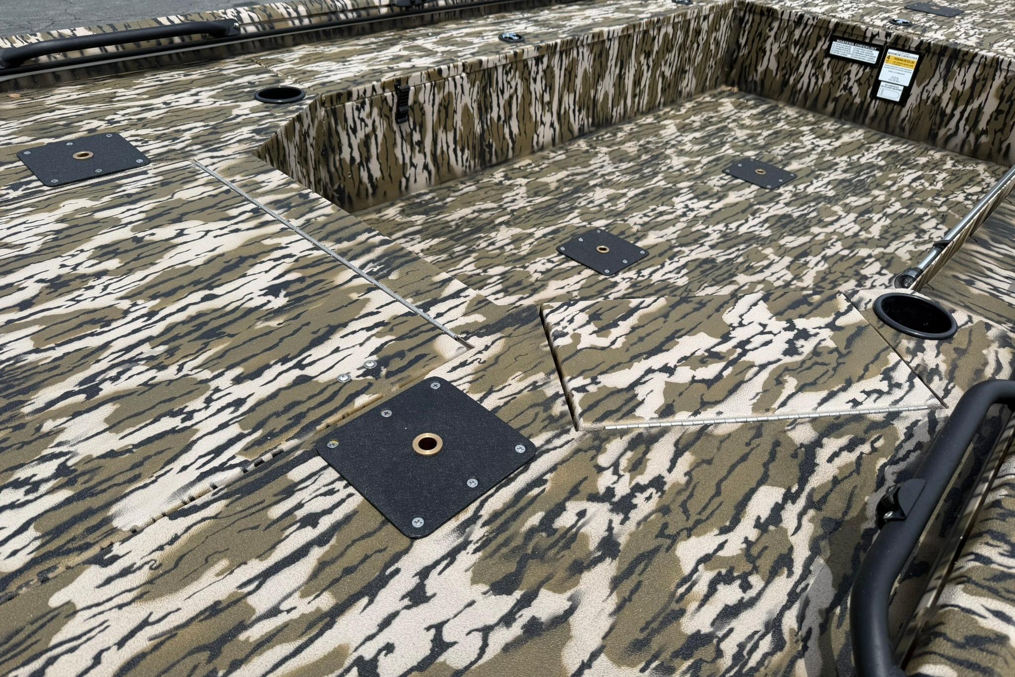 Camouflage-patterned deck of 2026 Avid 16 Commander boat, featuring multiple storage compartments.