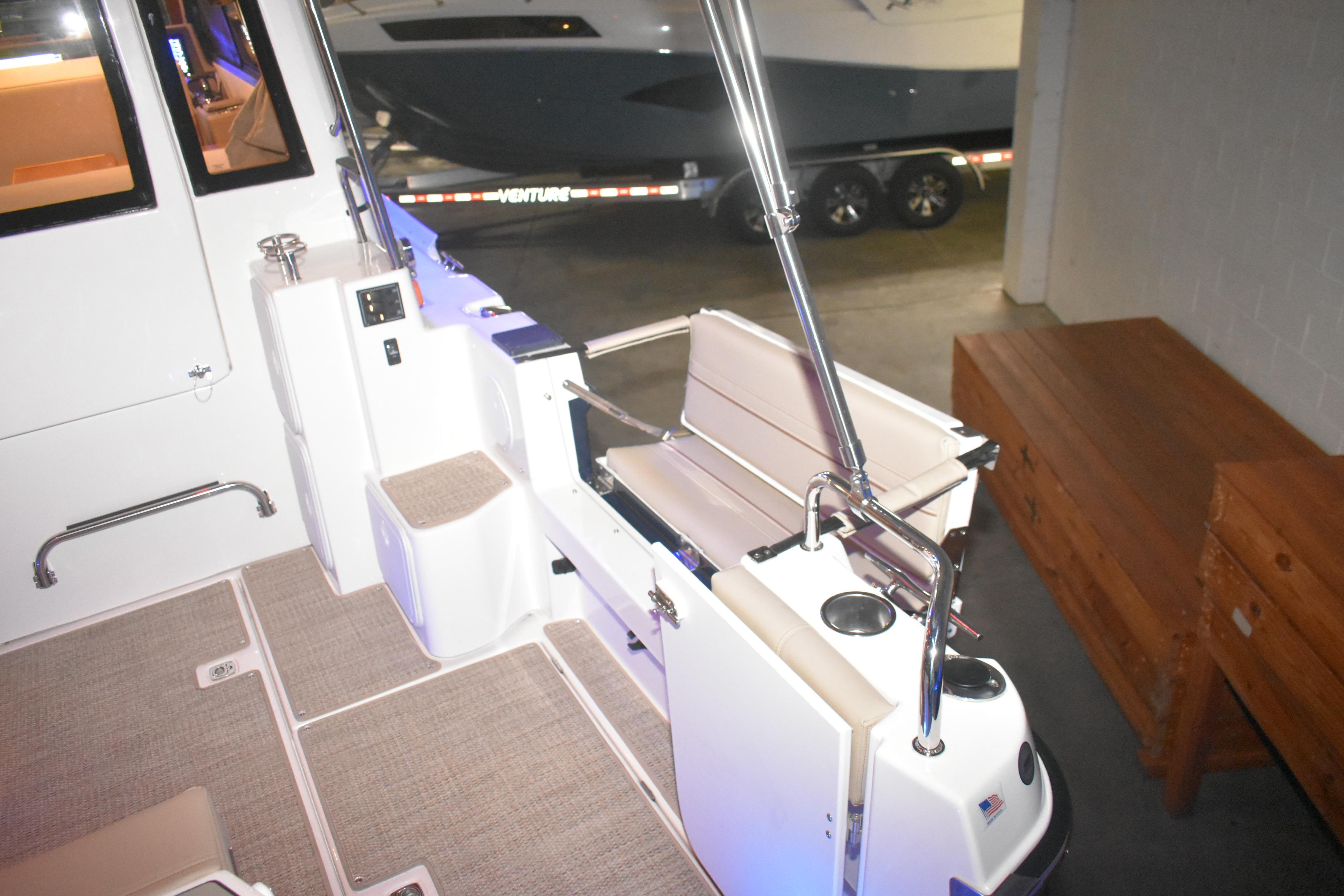 2026 Cutwater C-32 CB boat interior with seating and cup holders.