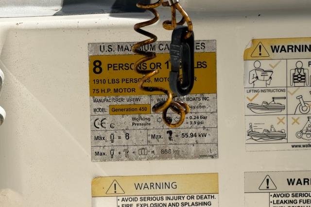 2016 Walker Bay Generation 450 DLX capacity label, showing 8-person limit and safety warnings.
