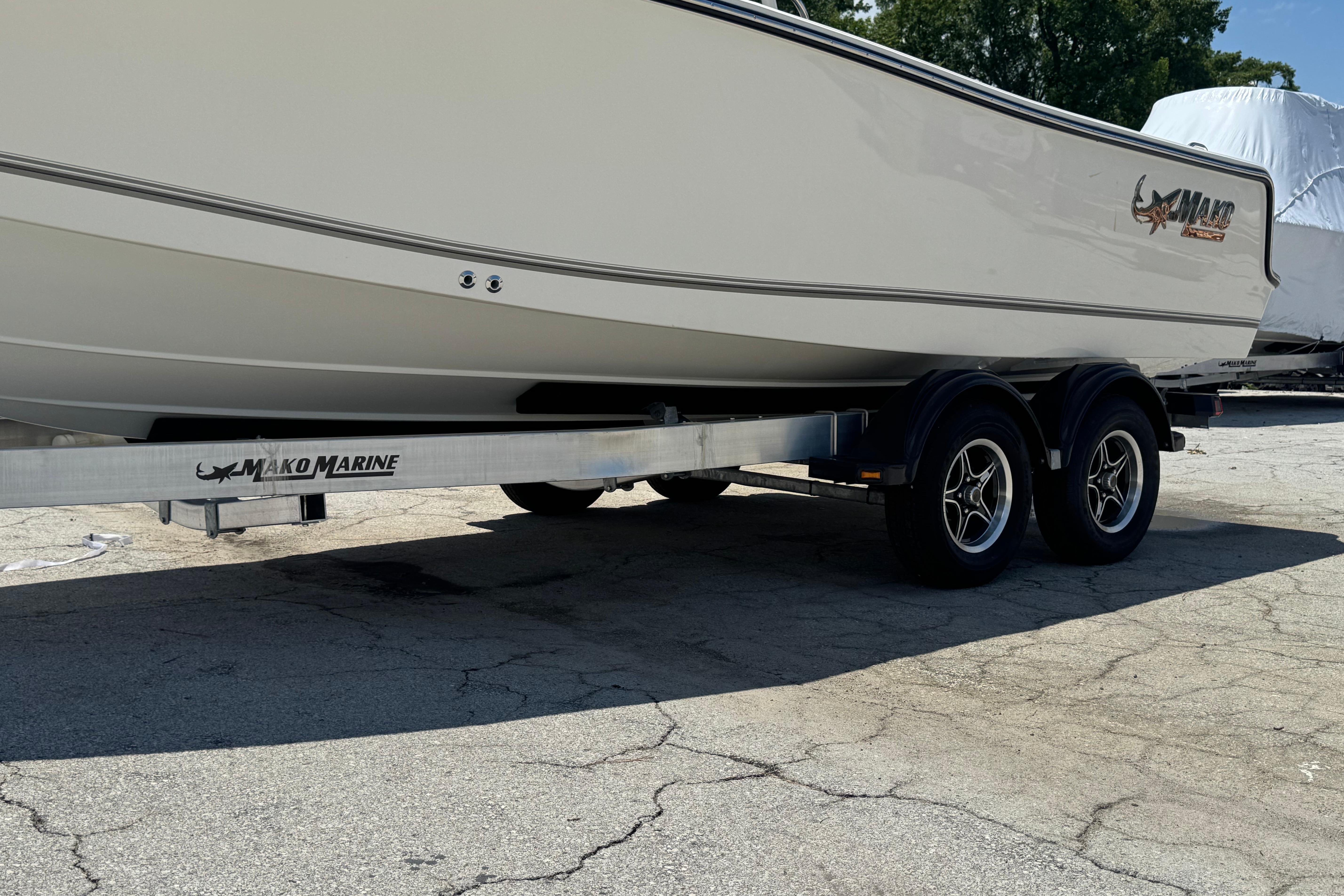 2026 Mako 214 Center Console boat on trailer, parked outdoors.