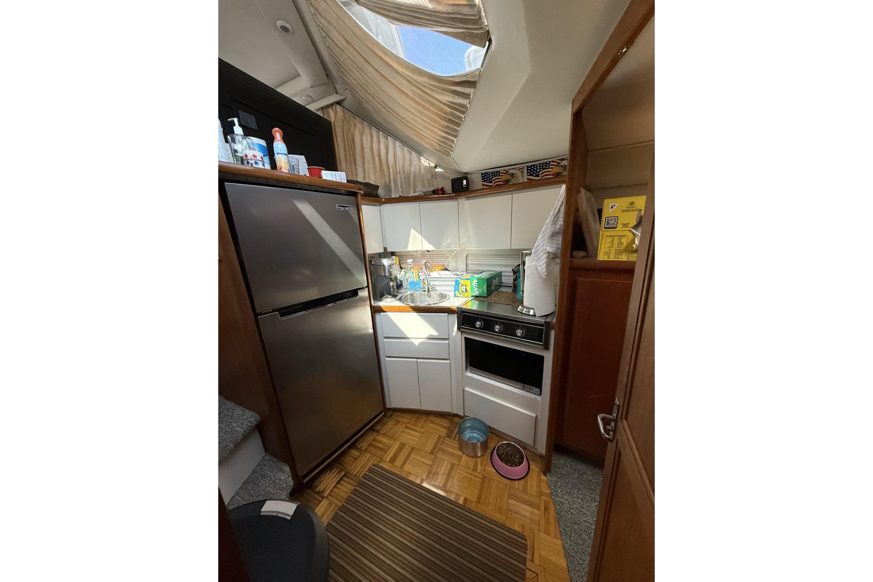 Kitchen area of a 1993 Carver 350 Motor Yacht with appliances and storage.