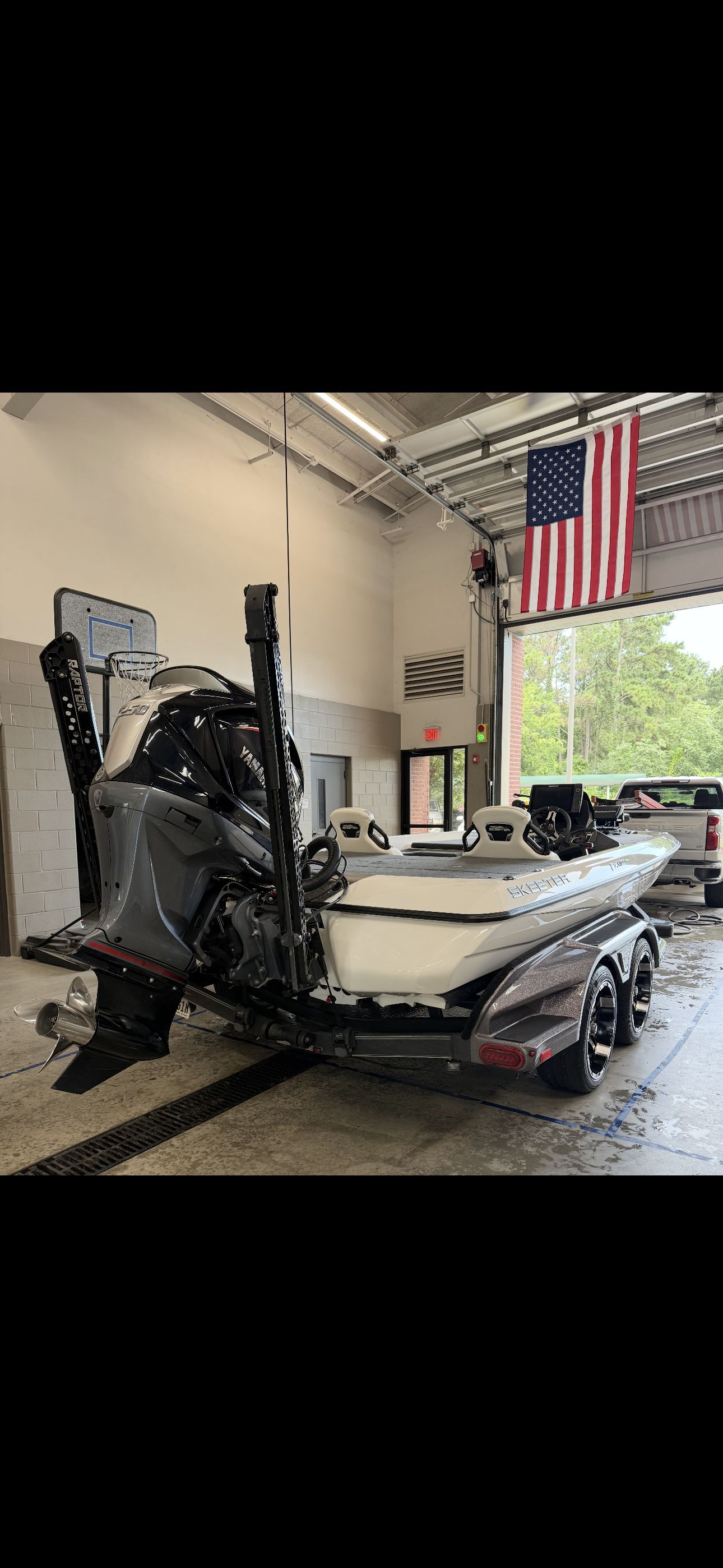 A 2022 Skeeter FXR20 Limited boat in a garage, featuring a powerful outboard motor.