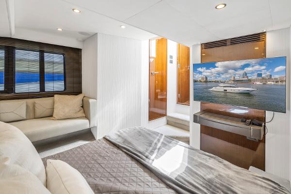 Luxurious interior of a 2013 Princess V57 yacht with TV and sofa.