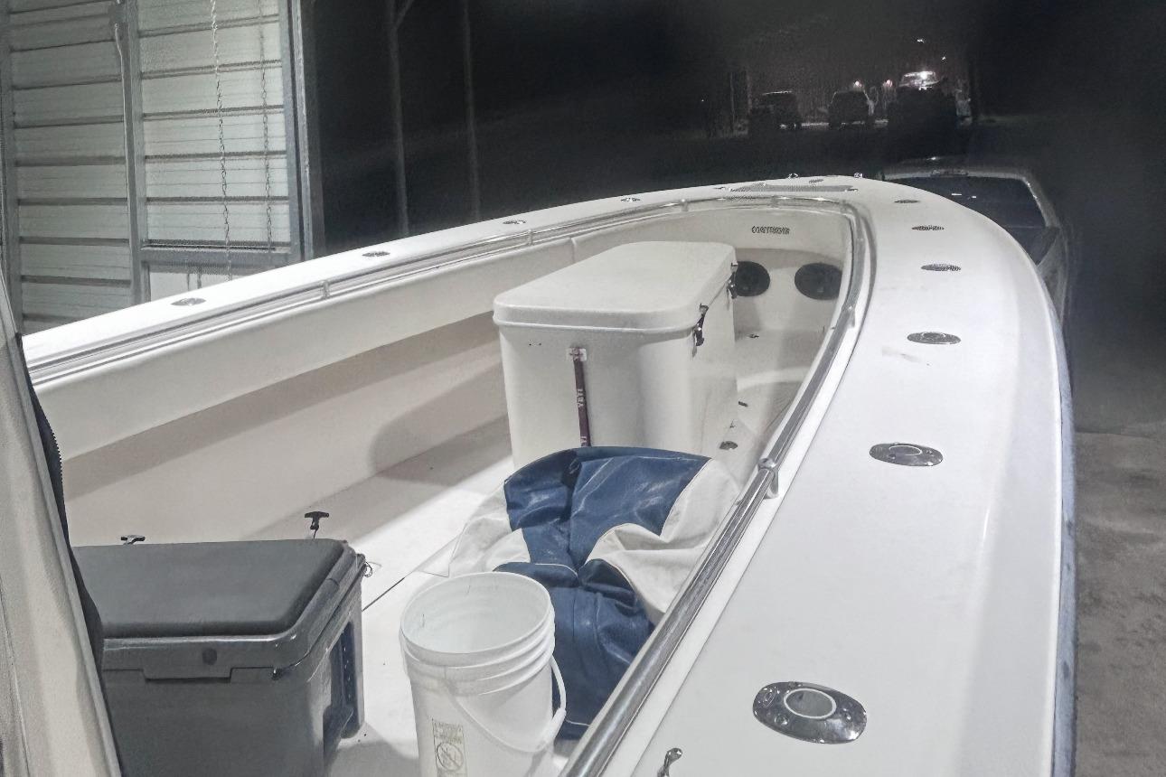 2005 Contender 35 ST boat interior with cooler and bucket in storage area.