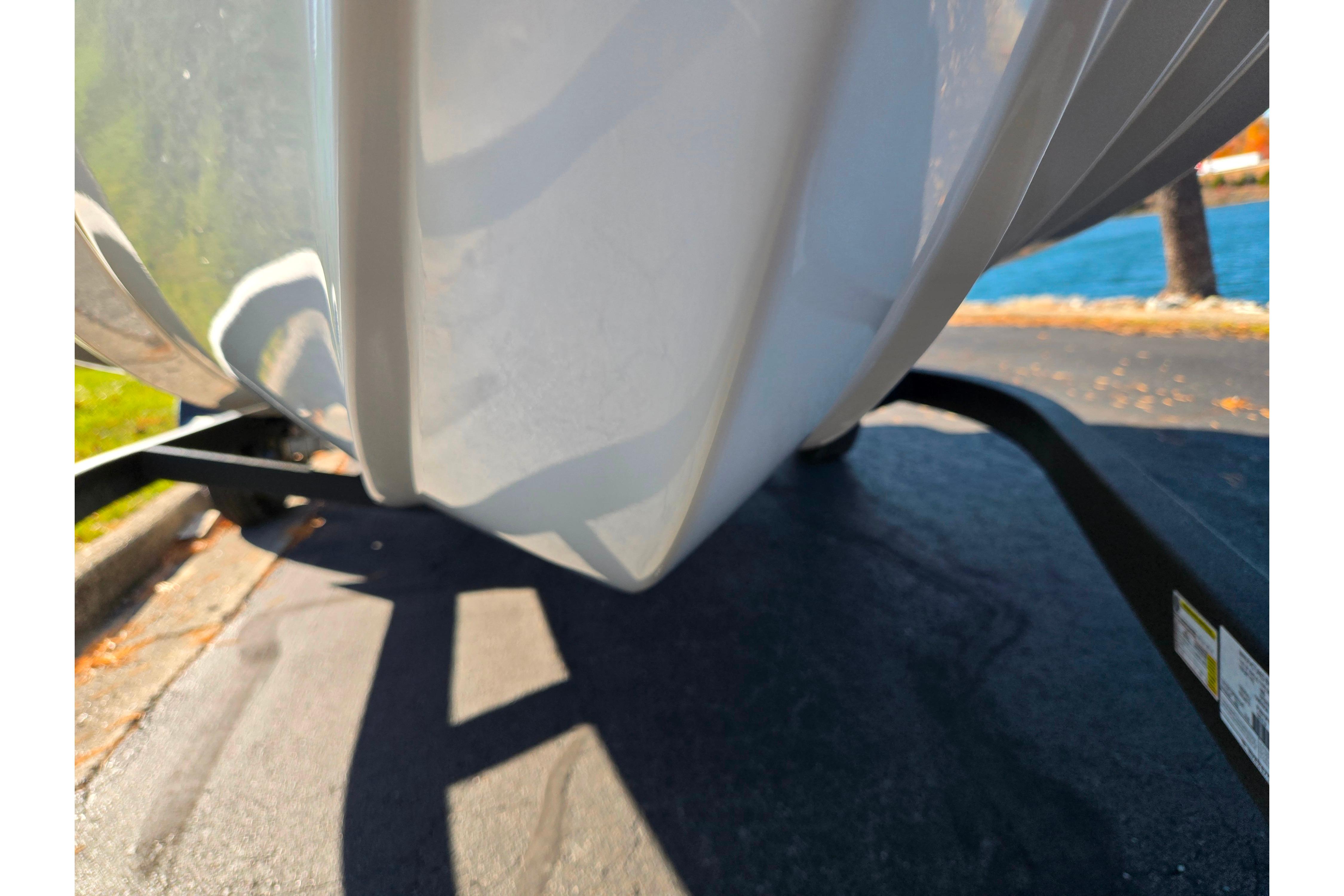 2023 Tahoe 185 S boat hull on trailer, parked near water.