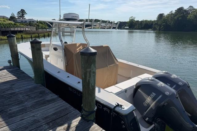 2014 Southport 29 FE boat docked by a serene lake with twin Yamaha engines.