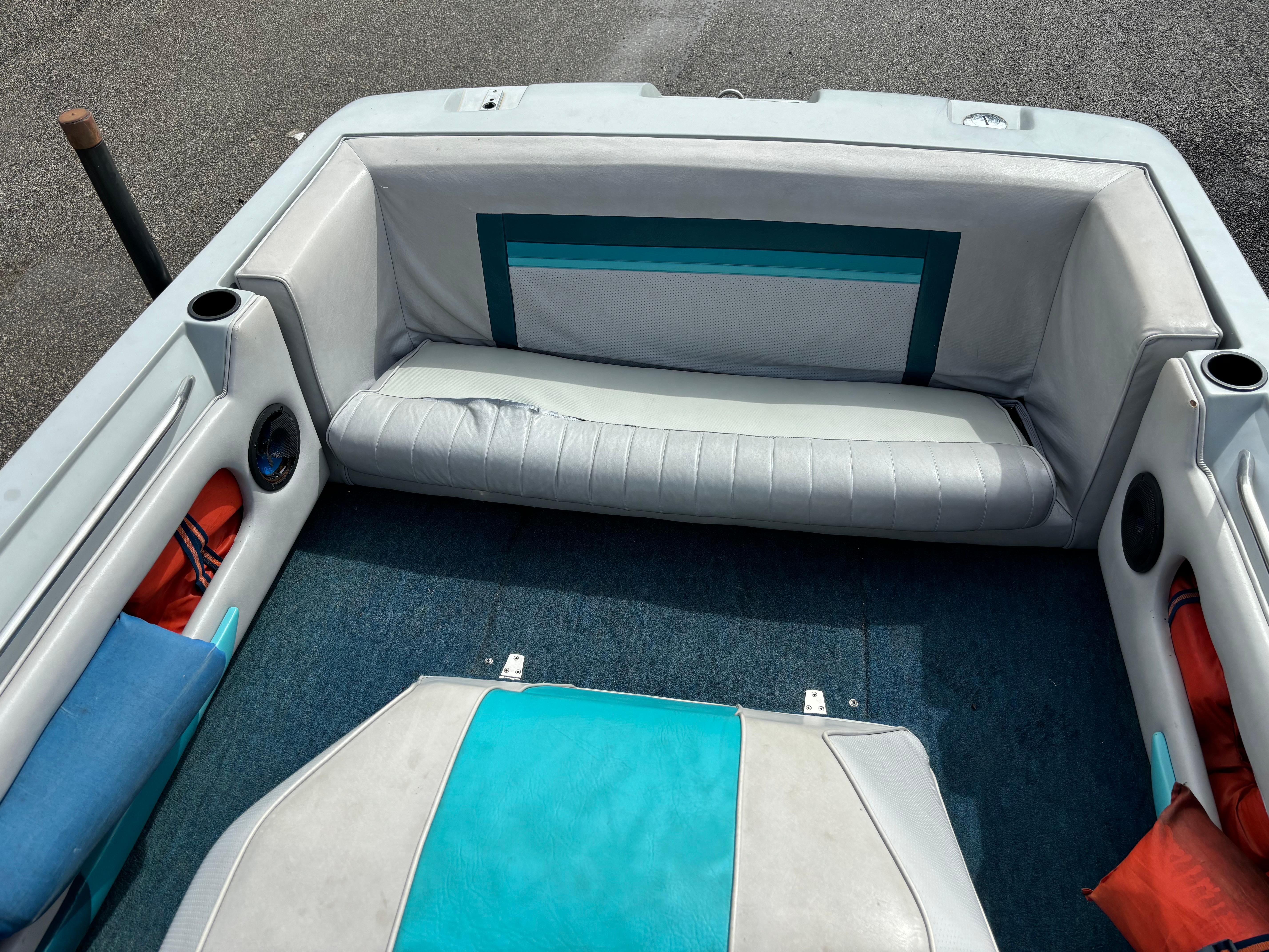 1989 MasterCraft ProStar 190 boat interior with teal and white seating.