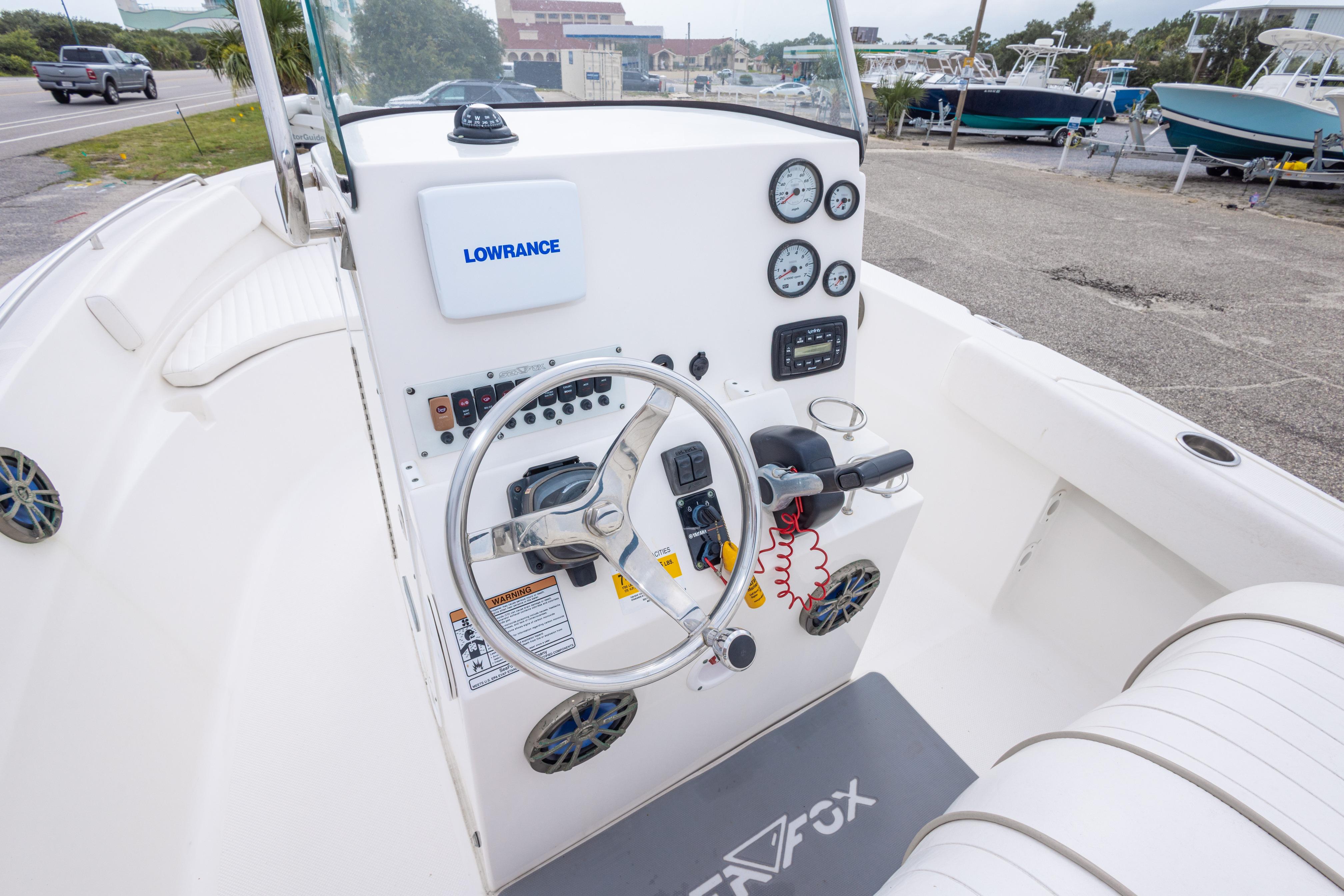 2014 Sea Fox 209 Commander boat dashboard with steering wheel and gauges.
