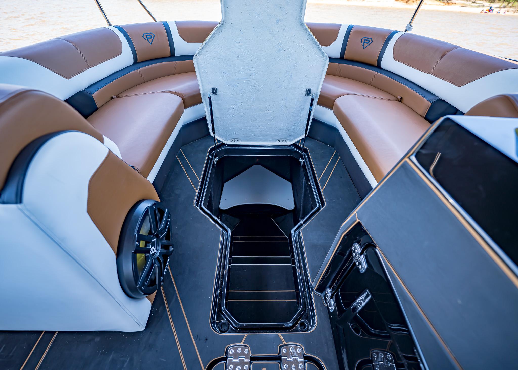 Luxurious interior of 2025 Paradigm 236 boat with brown and white seating.