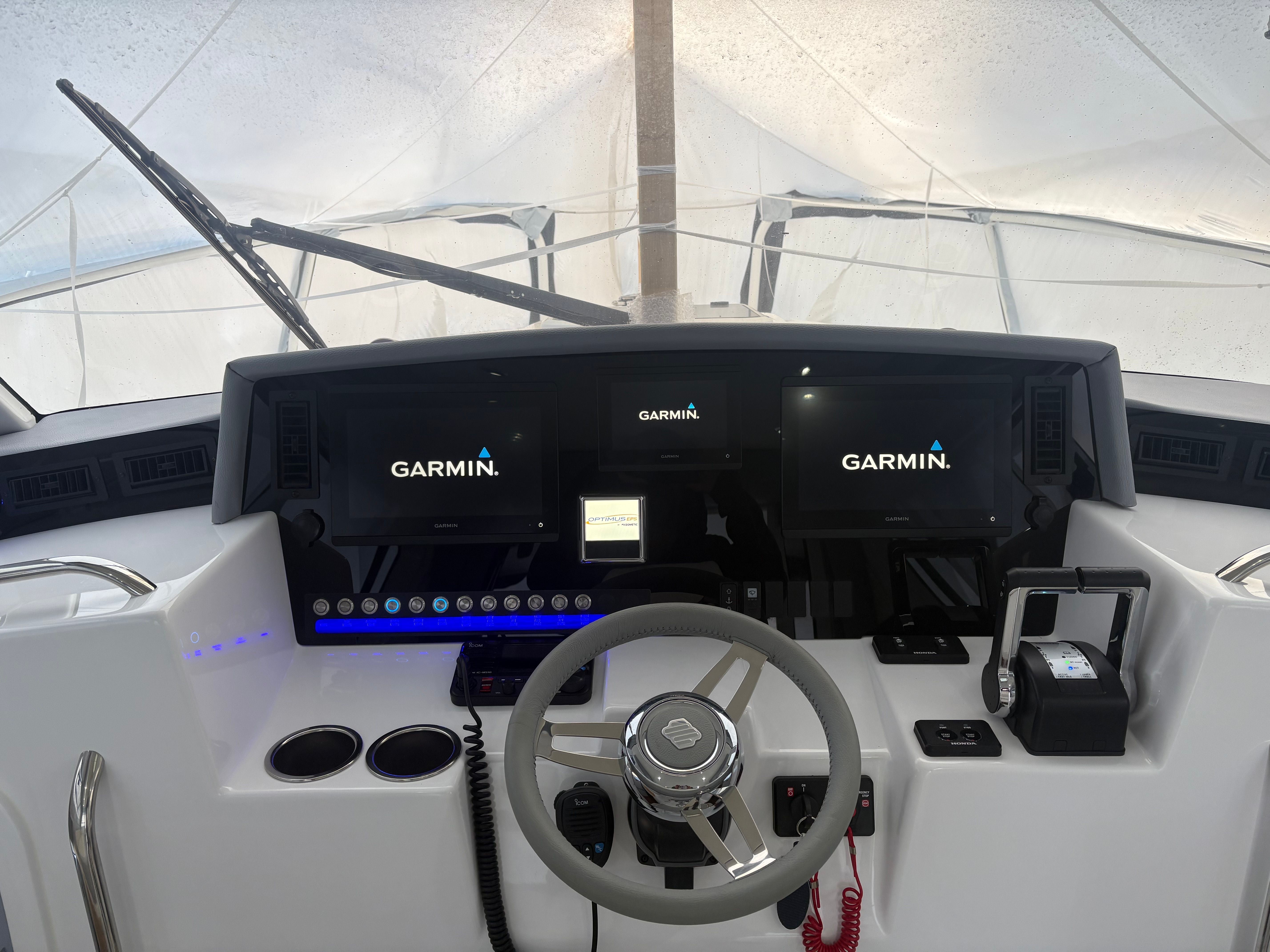 The cockpit of the 2024 ArrowCat 320 features modern Garmin displays and a sleek steering wheel.