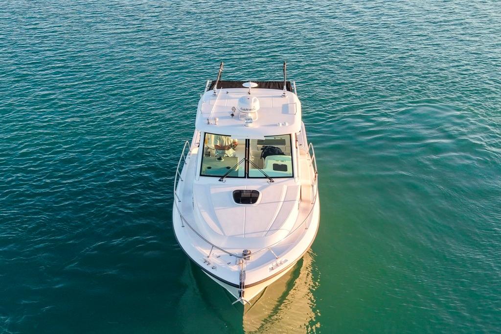 2014 Boston Whaler 315 Conquest boat on calm blue water, aerial view.