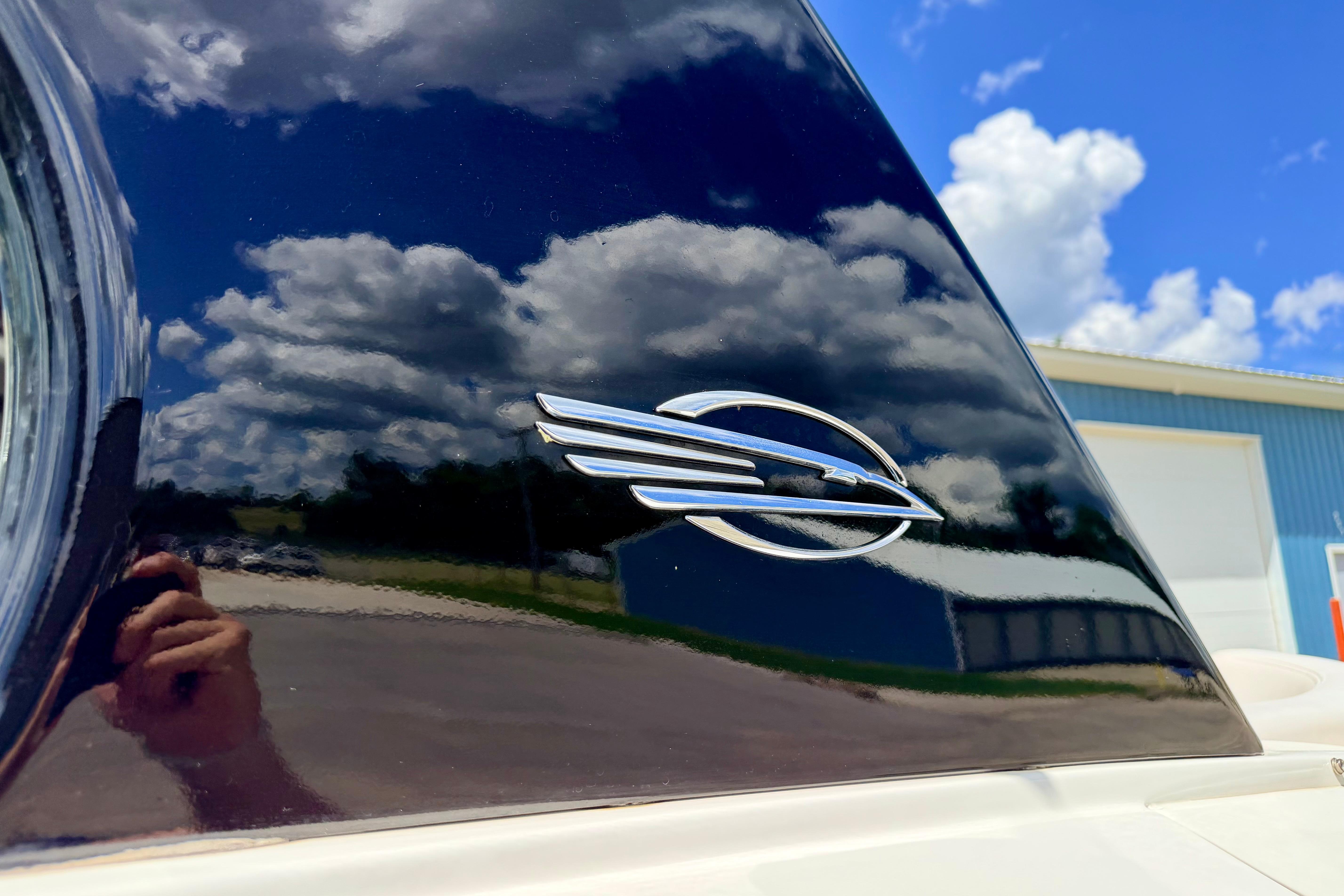 2015 Chaparral Sunesta 264 emblem with sky reflection on glossy surface.