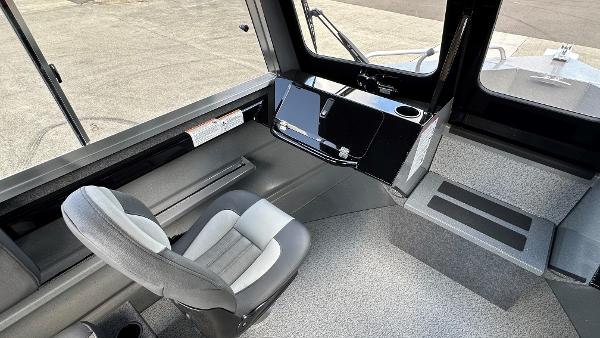 2024 Spartan 200 Astoria boat interior with modern helm and comfortable seating.