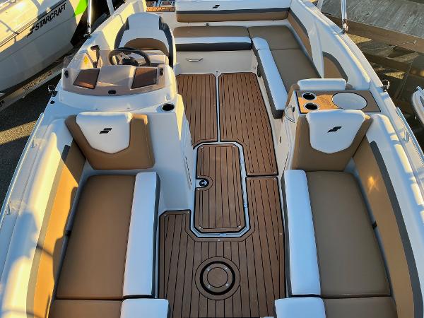 2024 Starcraft SVX 191 boat interior with tan and white seating and wood flooring.