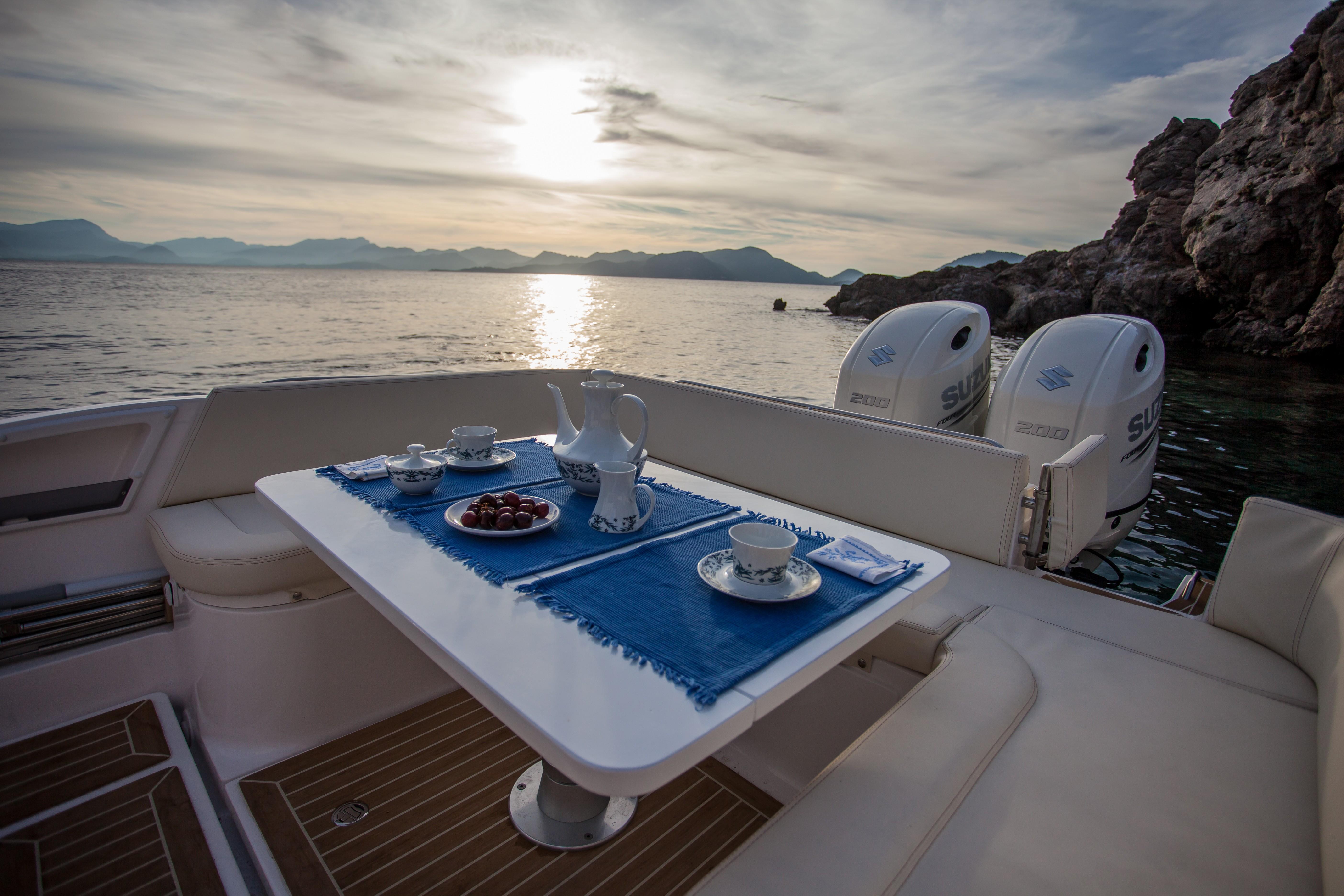 Luxury dining setup on Zar Formenti 85 SL boat, 2025 model, with scenic ocean view.