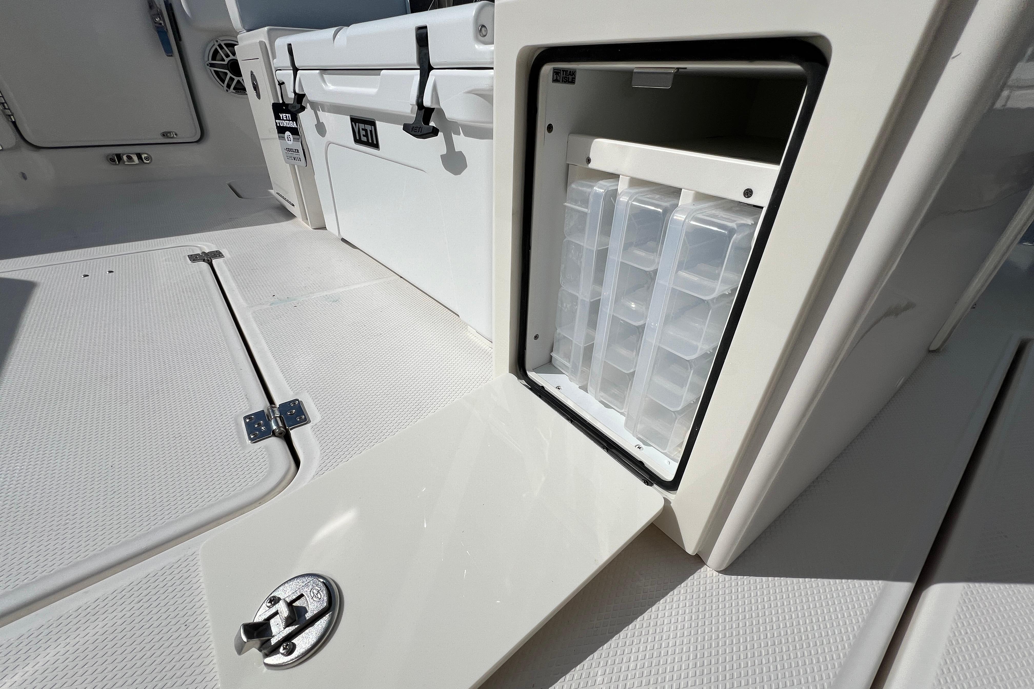 2026 Robalo R300 Center Console boat with open storage compartment and Yeti cooler.