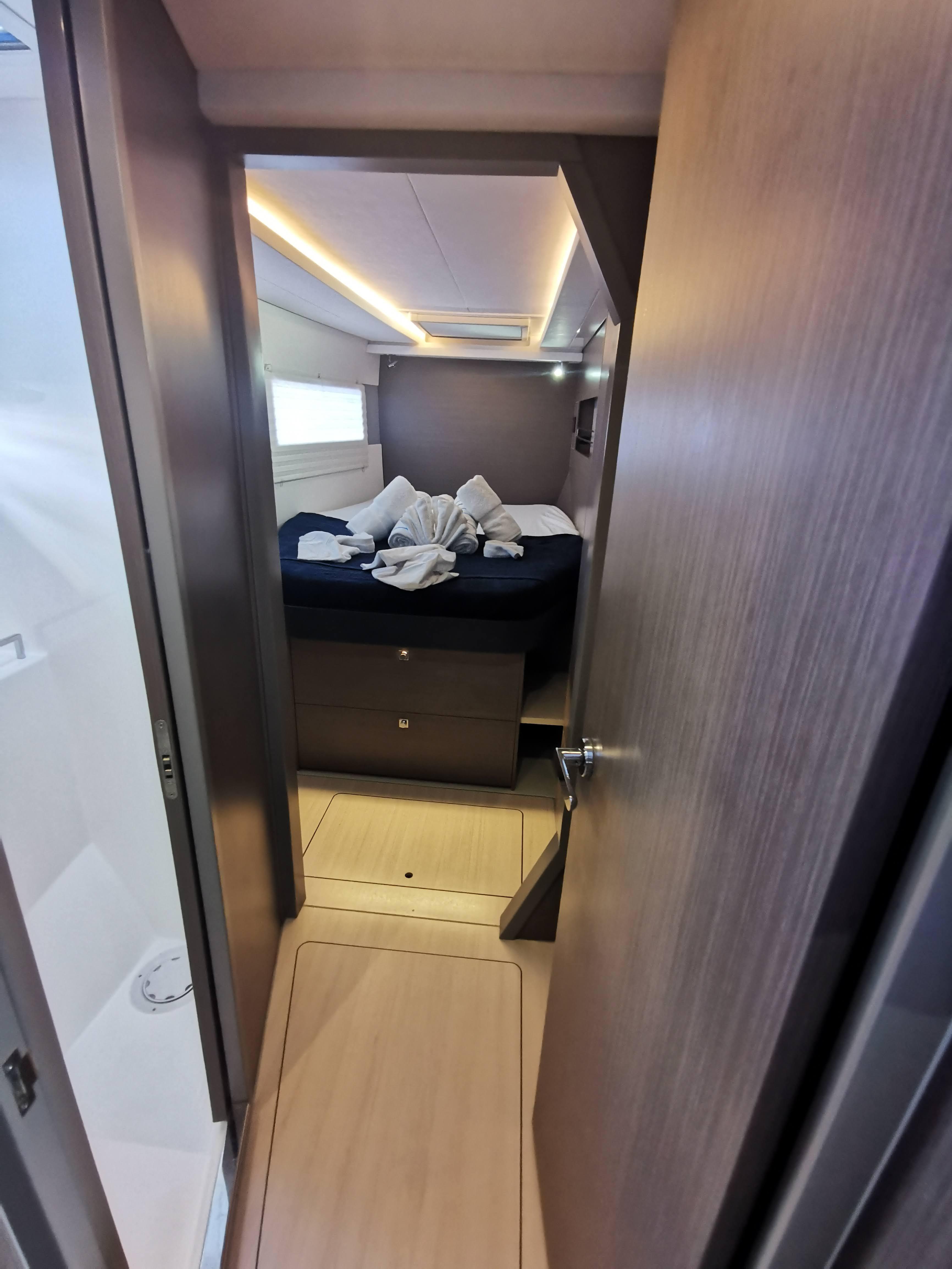 Interior cabin of a 2022 Leopard 45 yacht with modern design and cozy bedding.