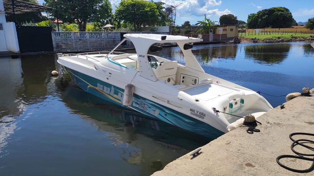 2011 Fountain Express Cruiser docked in a serene waterfront setting.