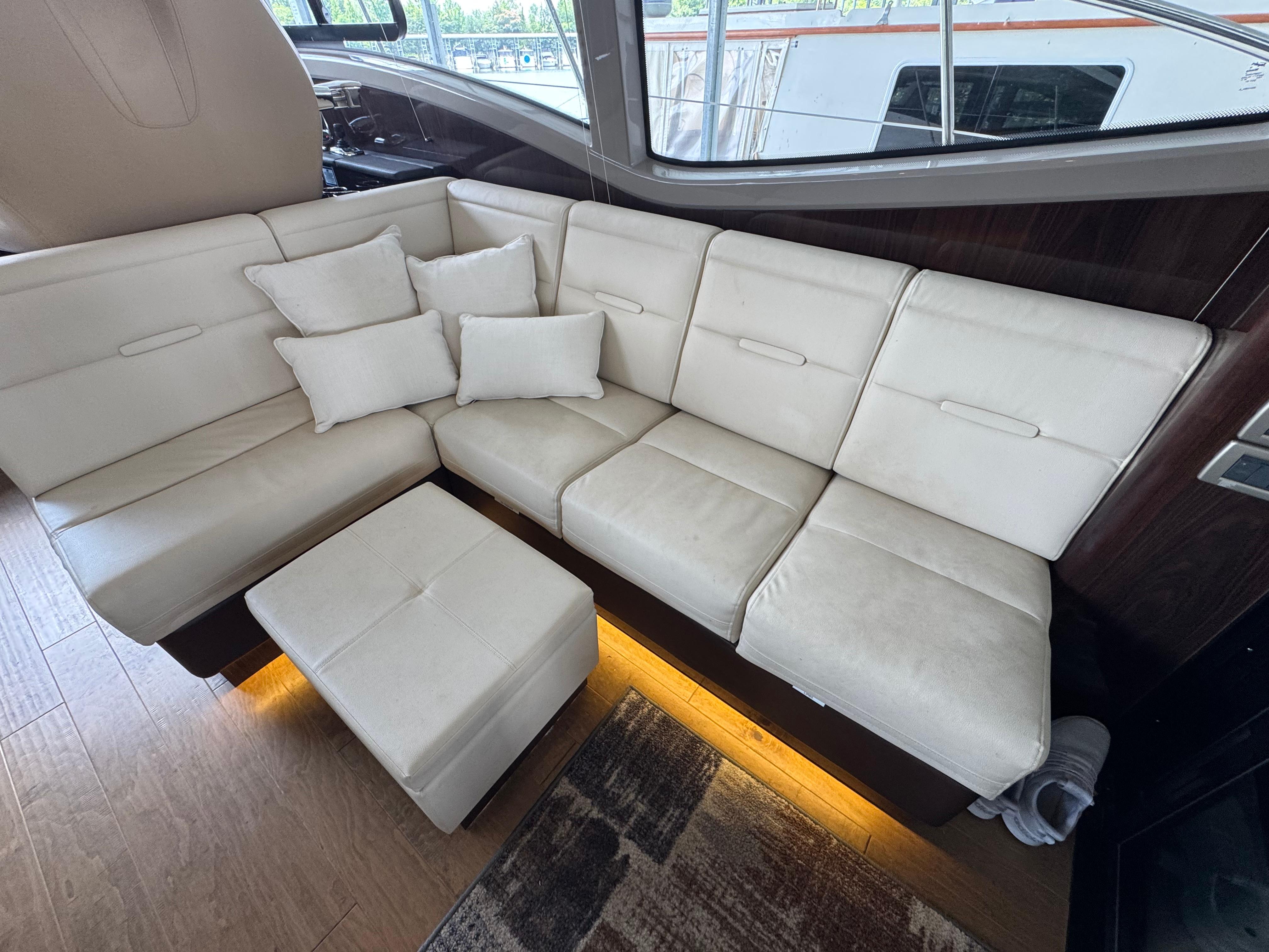 Luxurious interior of 2017 Sea Ray Sundancer 400 with cream leather seating and cushions.