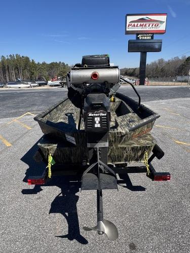 2025 SeaArk 1752 Slayer Pro boat with motor, parked outdoors near dealership.