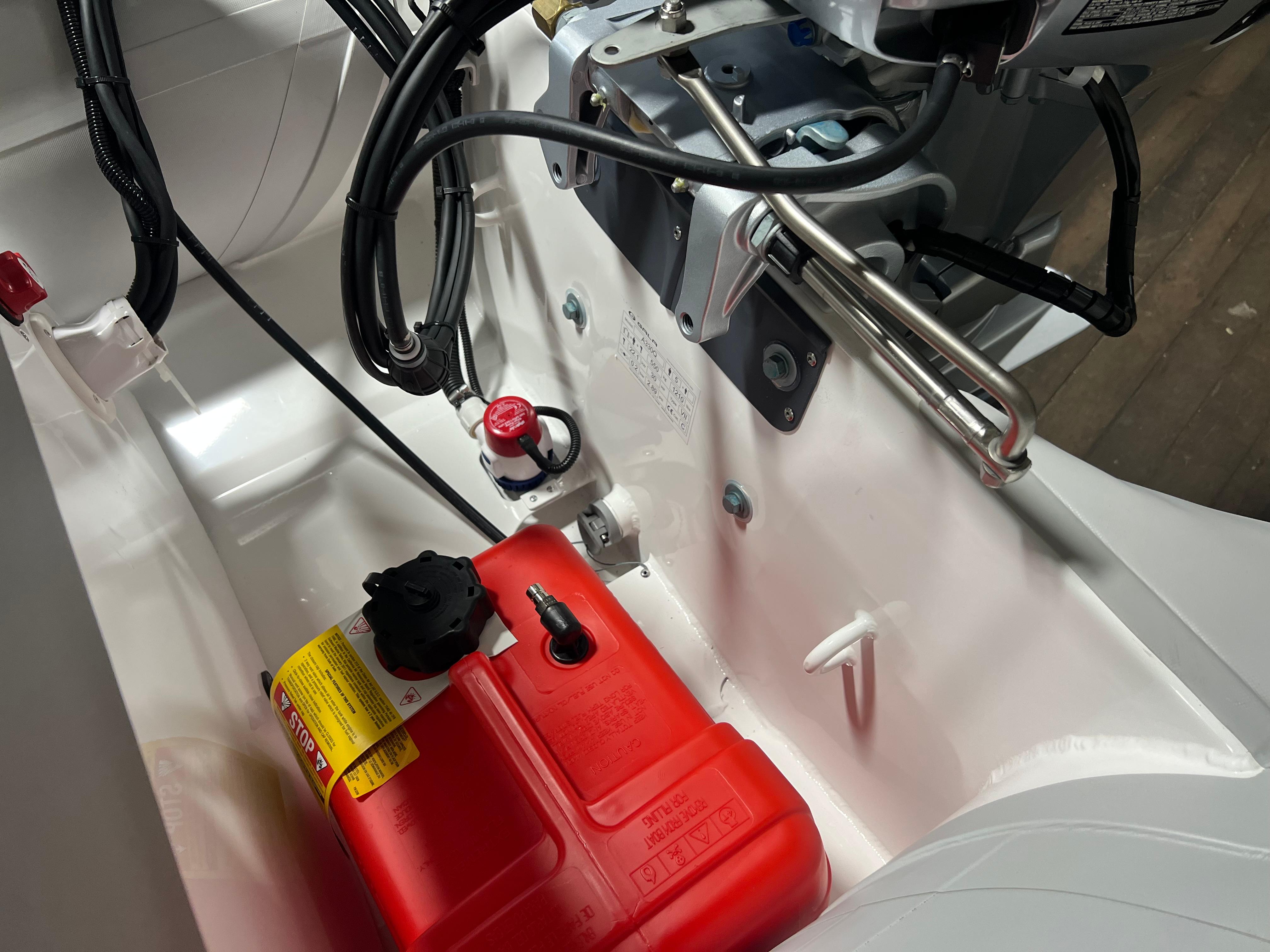 2023 Gala A330Q boat engine compartment with red fuel tank and wiring.