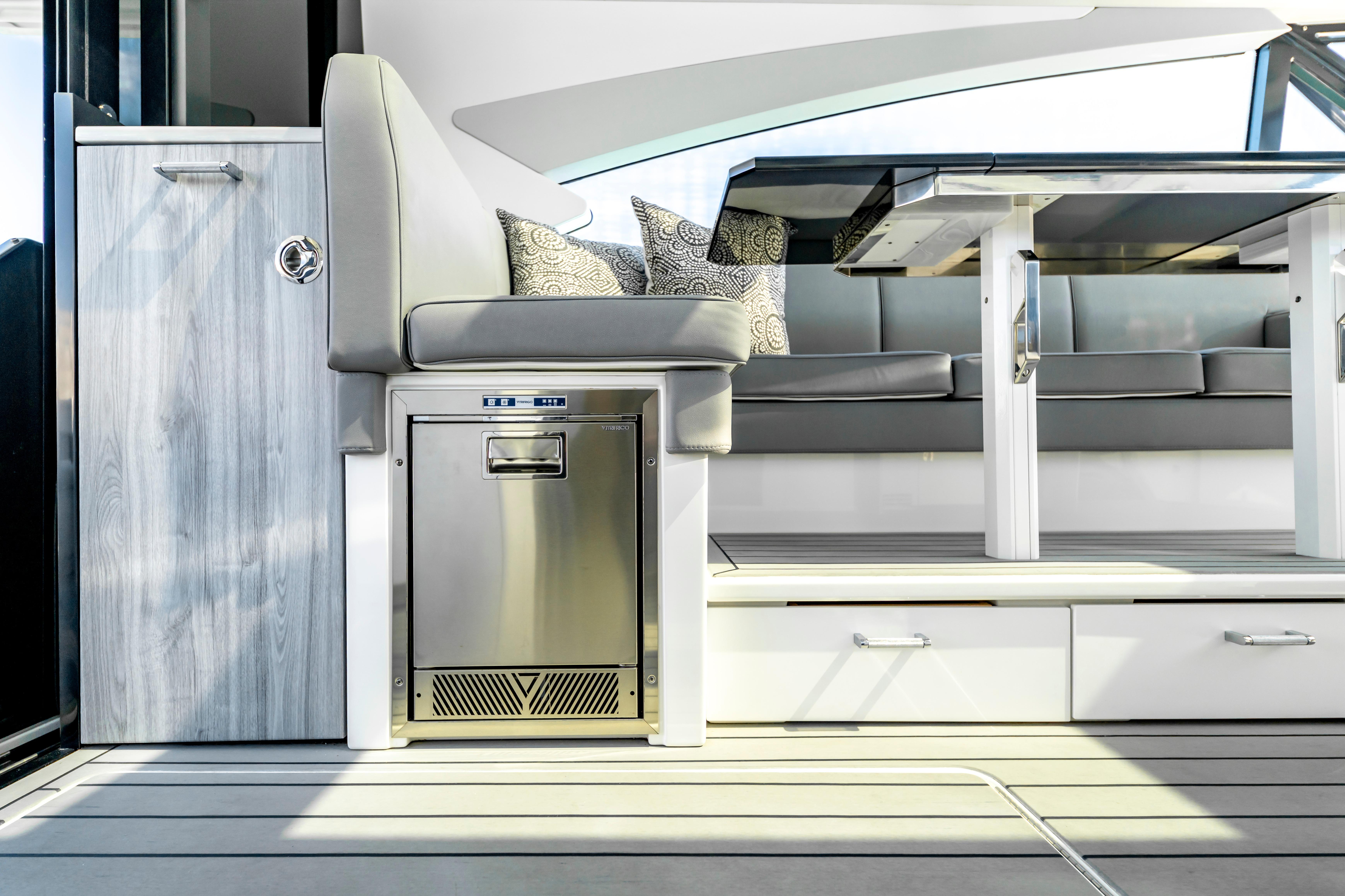 Luxurious interior of 2022 Formula 500 Super Sport Crossover yacht with modern seating and table.