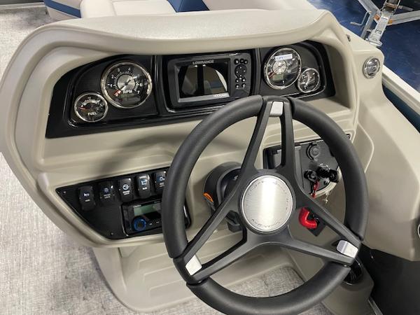 2025 South Bay LE boat dashboard with steering wheel and control panel.