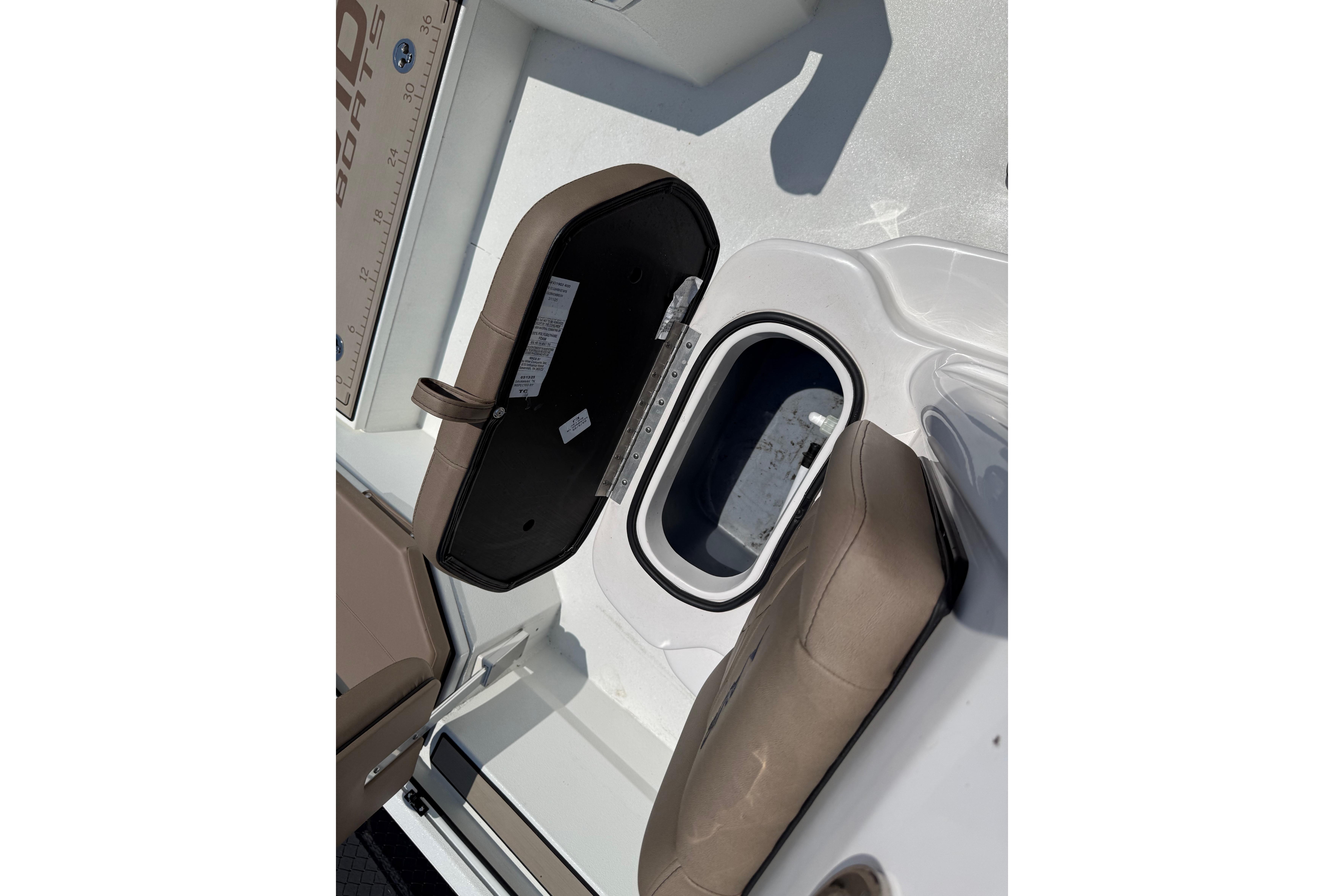 Open storage compartment on 2025 Avid 22 Recon boat with cushioned seating.