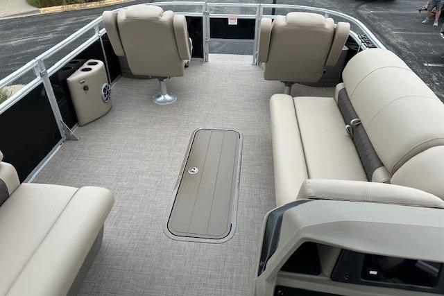 2025 Sun Tracker Sportfish 24 XP3 pontoon boat interior with beige seating and spacious layout.