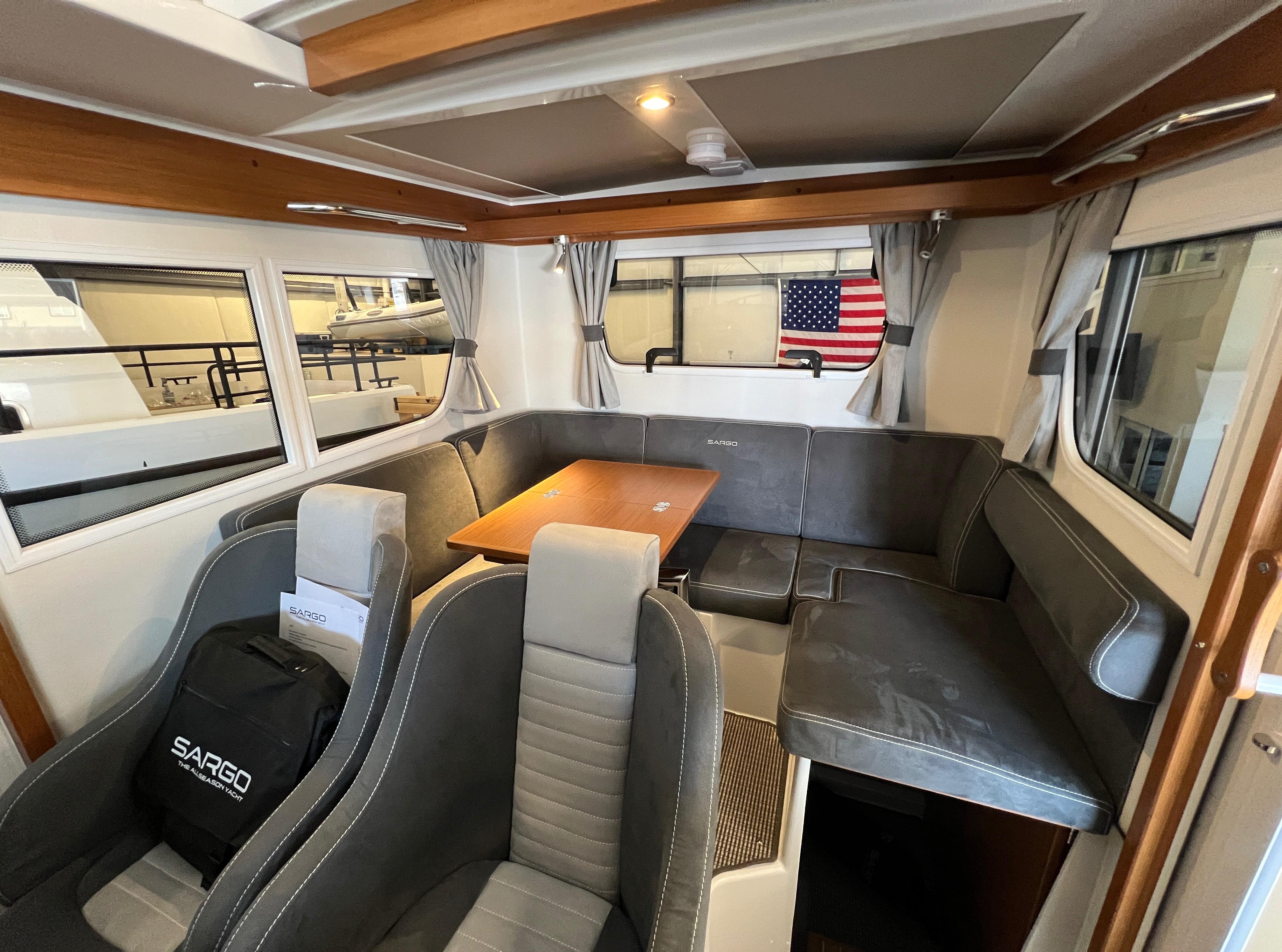 Interior of 2024 Sargo 28 boat with seating area and table.