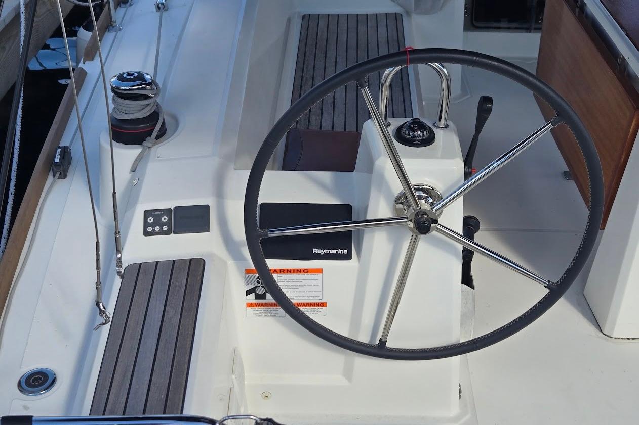 Steering wheel of 2023 Beneteau Oceanis 38.1 sailboat with Raymarine equipment.