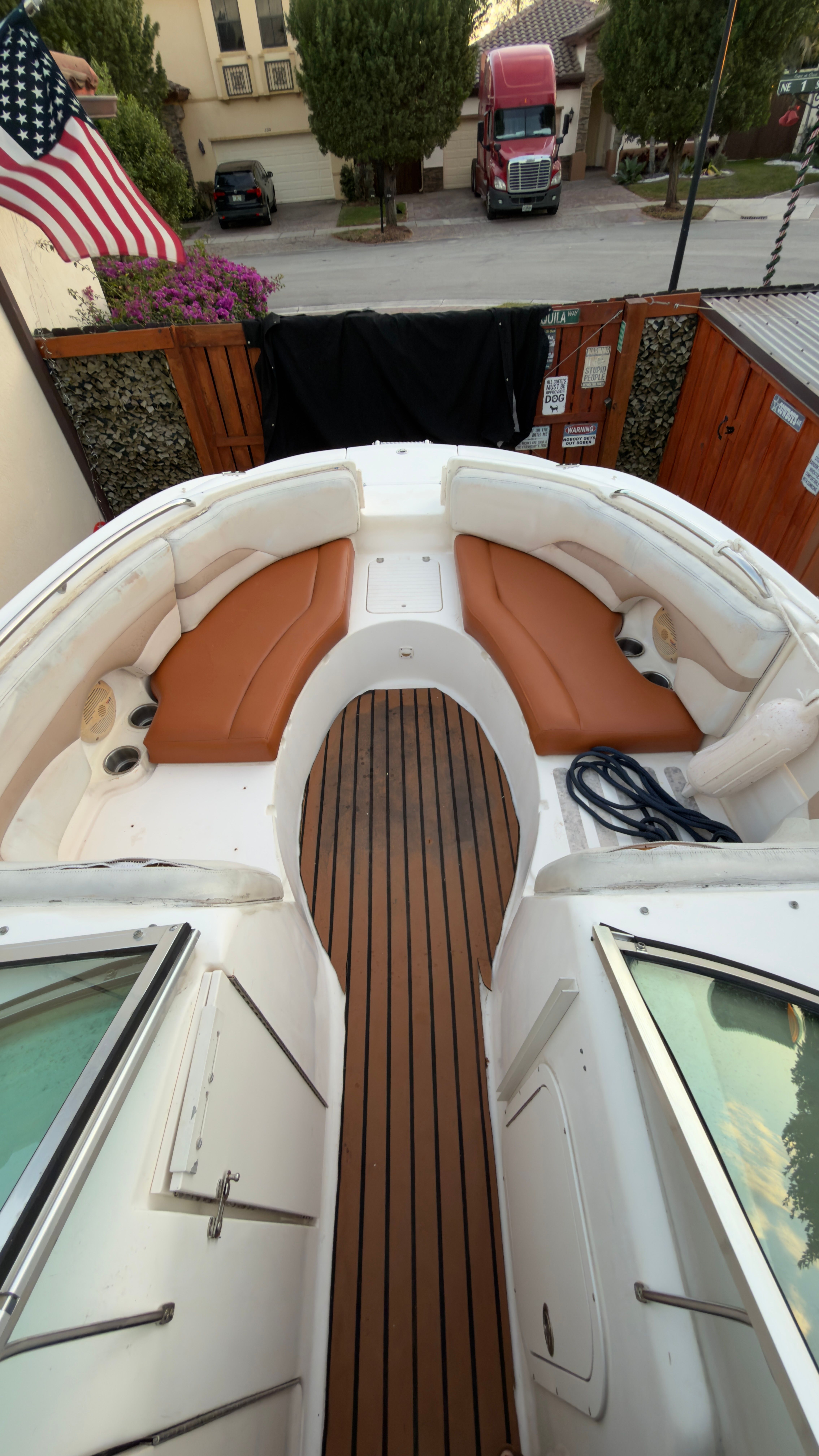 2003 Chaparral 263 Sunesta Deckboat with wood deck and seating area.