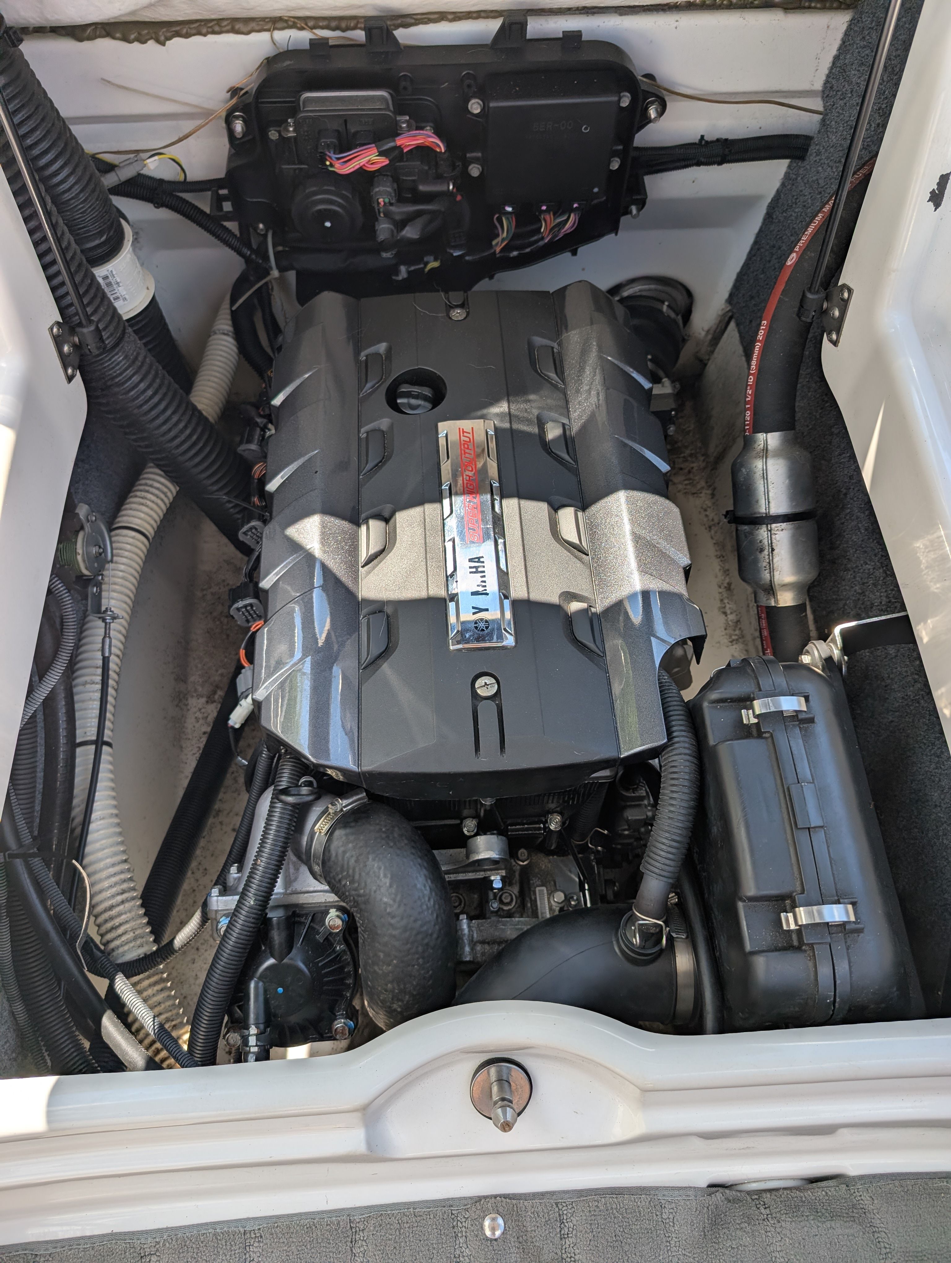 The engine compartment of a 2014 Yamaha AR192 boat with visible engine and wiring.