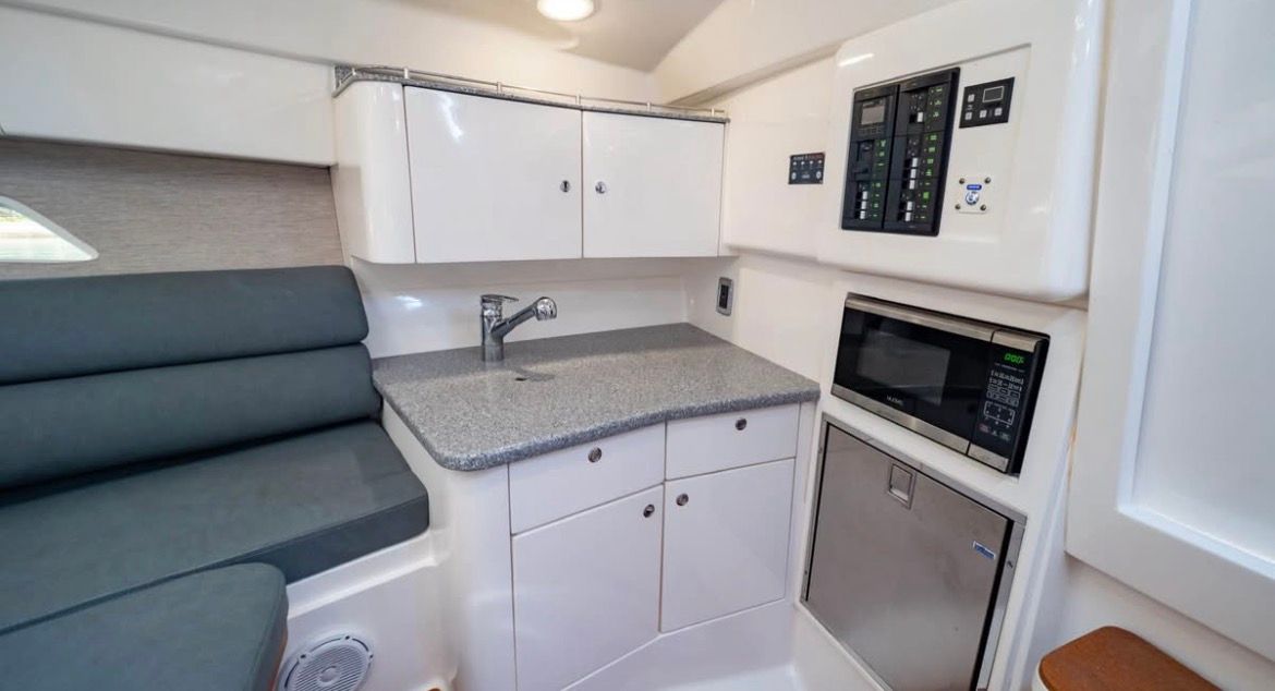 Interior of 2018 Intrepid 375 yacht with kitchenette and seating area.