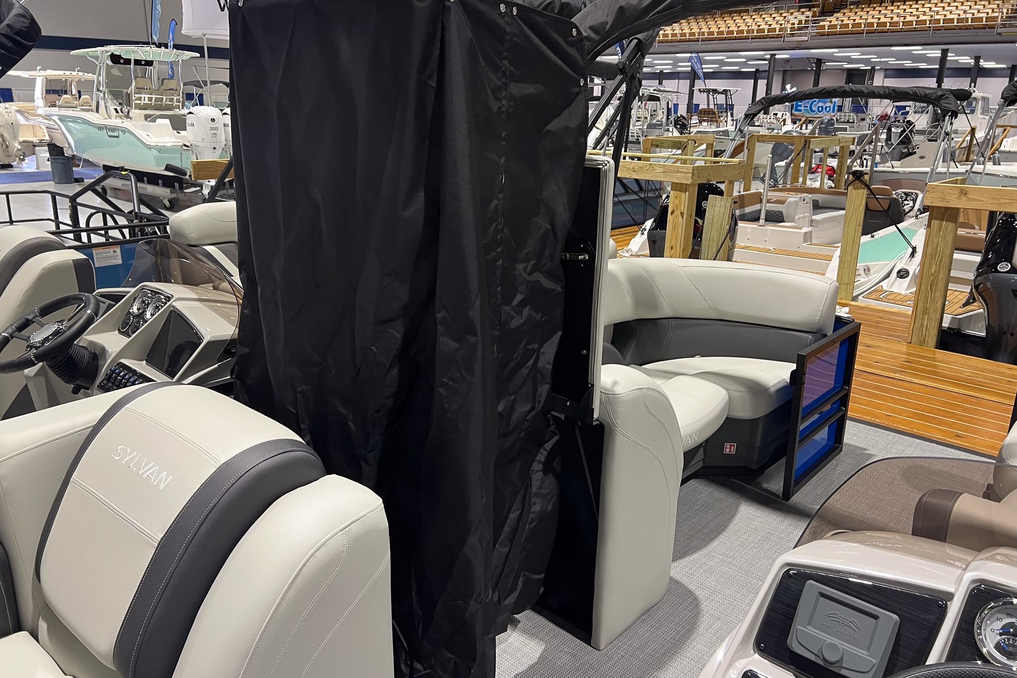 2026 Sylvan Mirage 822 CLZ boat interior with plush seating and modern dashboard.