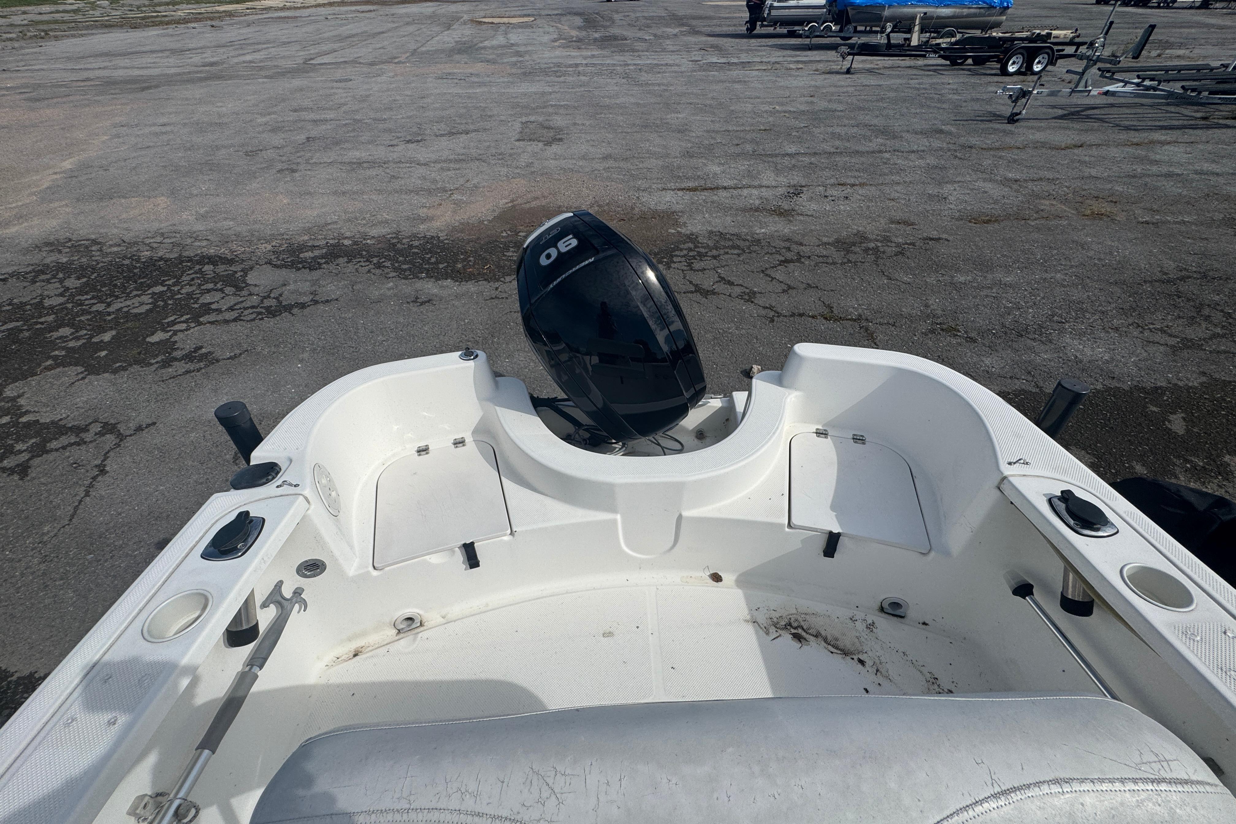 2007 Trophy 1703 Center Console boat with outboard motor on a paved surface.