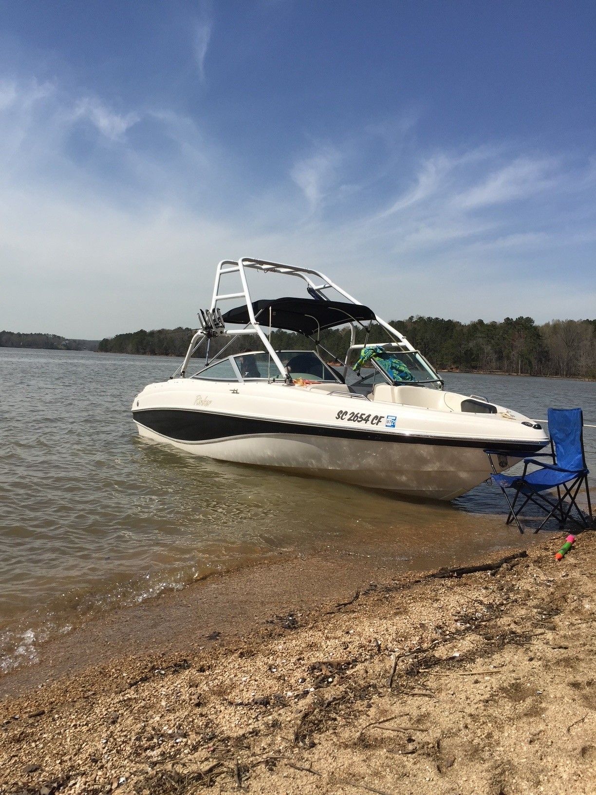 2002 Rinker 212 Captiva Bowrider on a sandy lakeshore.