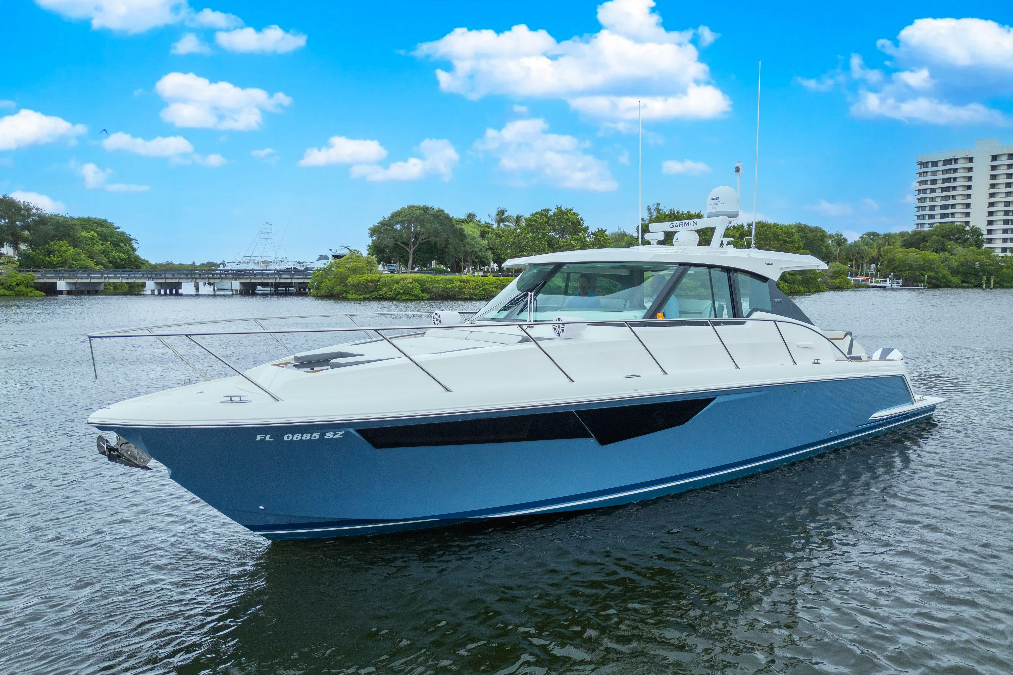 2021 Tiara Sport 43 LE boat on calm water under blue sky.