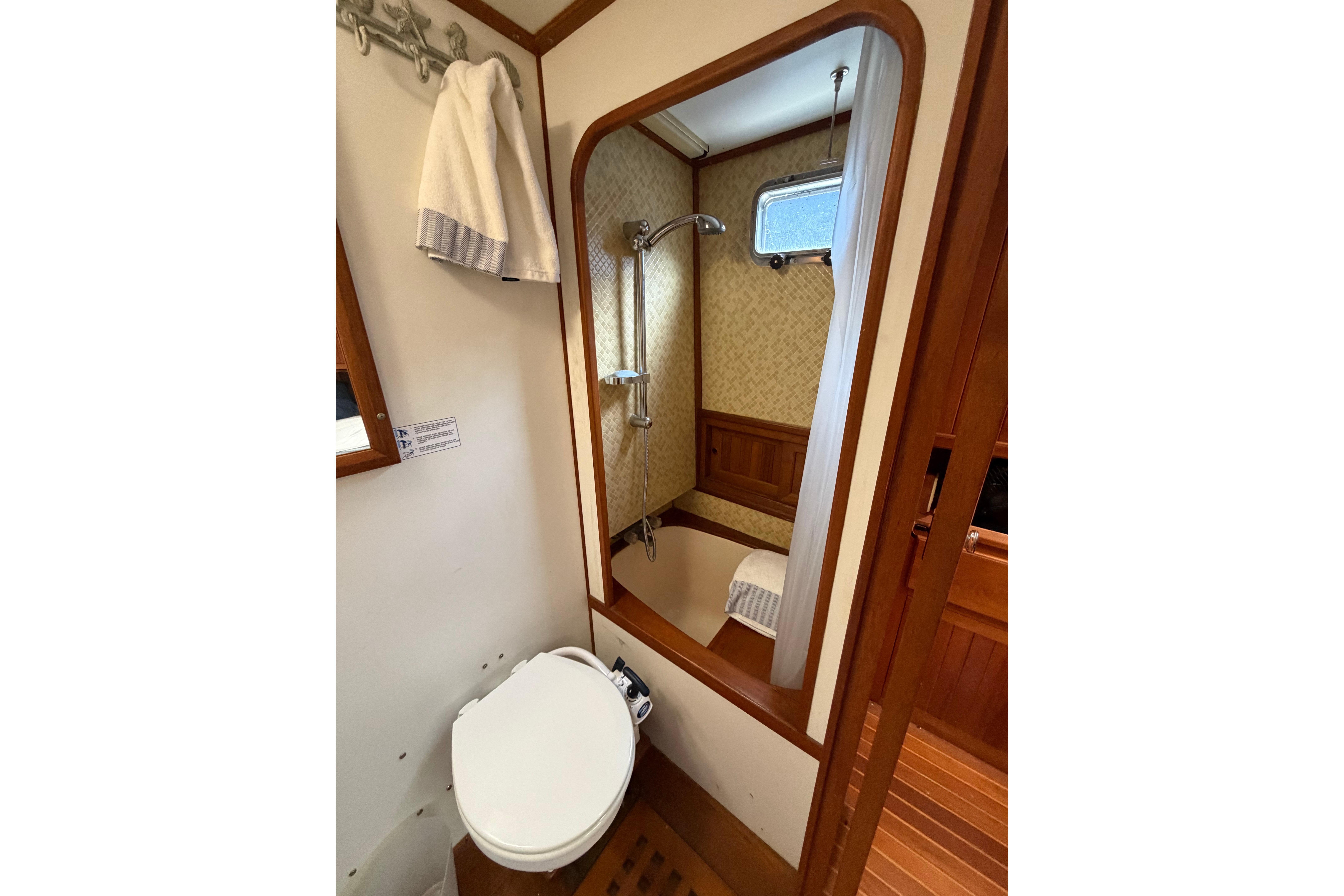 Compact bathroom in 1988 Monk 36 boat with shower and toilet.