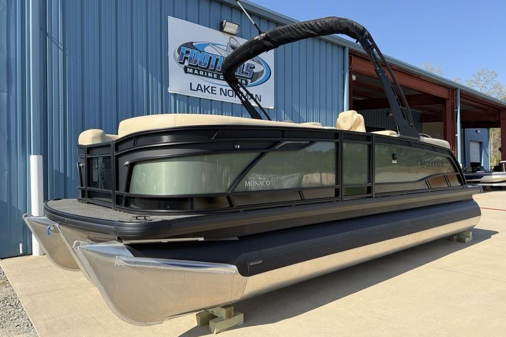 2026 Godfrey Monaco 235 SB pontoon boat displayed at a marine center.