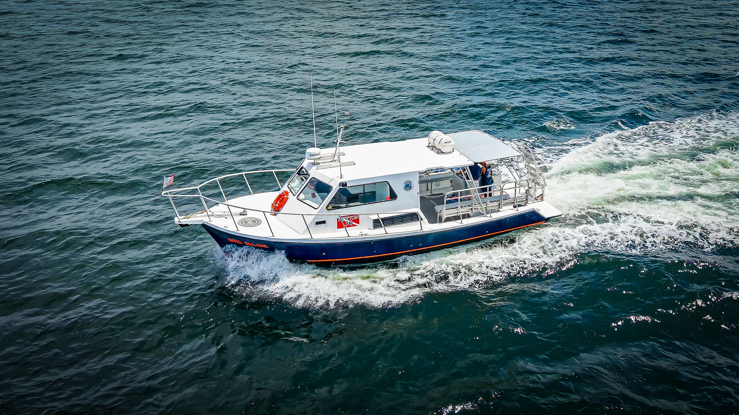 Newton 36' Dive Special from 2019 on the water, featuring a spacious deck and safety equipment.