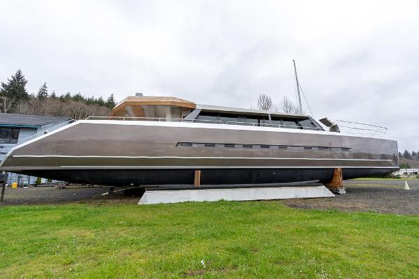 2025 Catamaran Bloomfield 86 Motorsailor on land, sleek design, overcast sky.