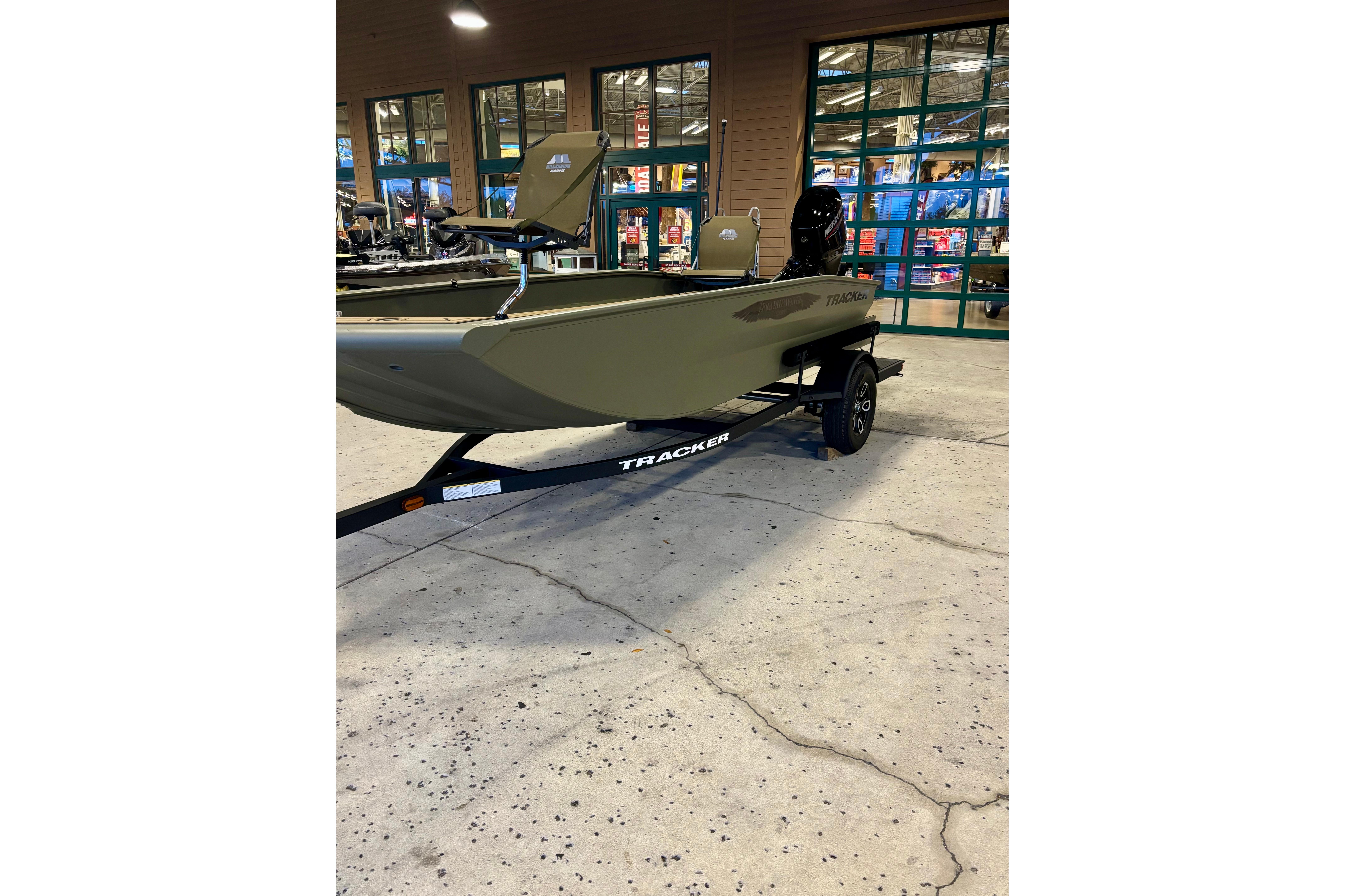 2026 Tracker Grizzly 1650 T Prairie Wings Edition boat on display indoors.