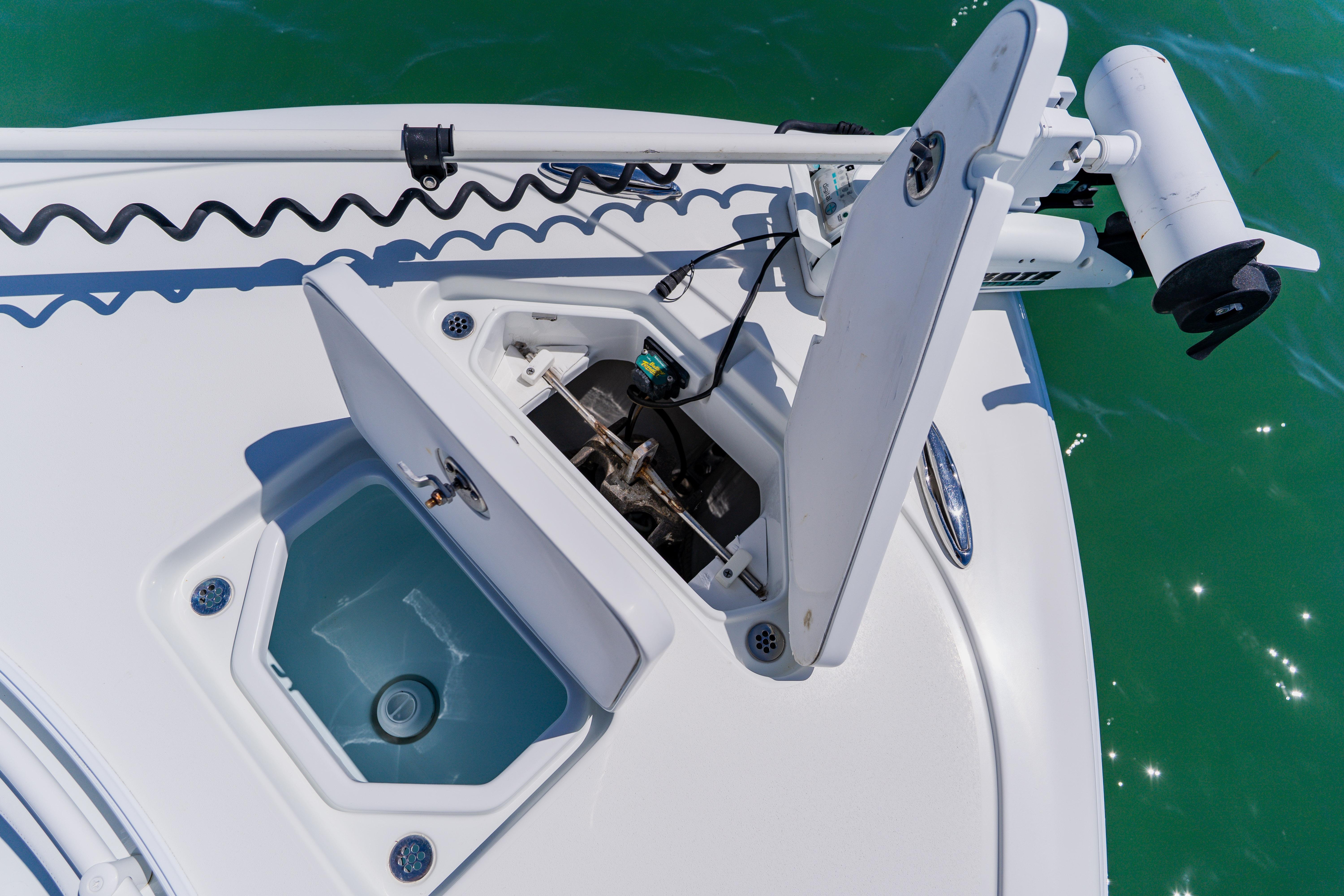 2017 Barker Boatworks 26 showing open storage compartments on deck.