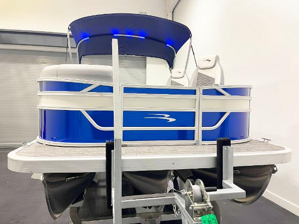 2025 Bennington 20S pontoon boat with blue exterior and canopy in showroom.