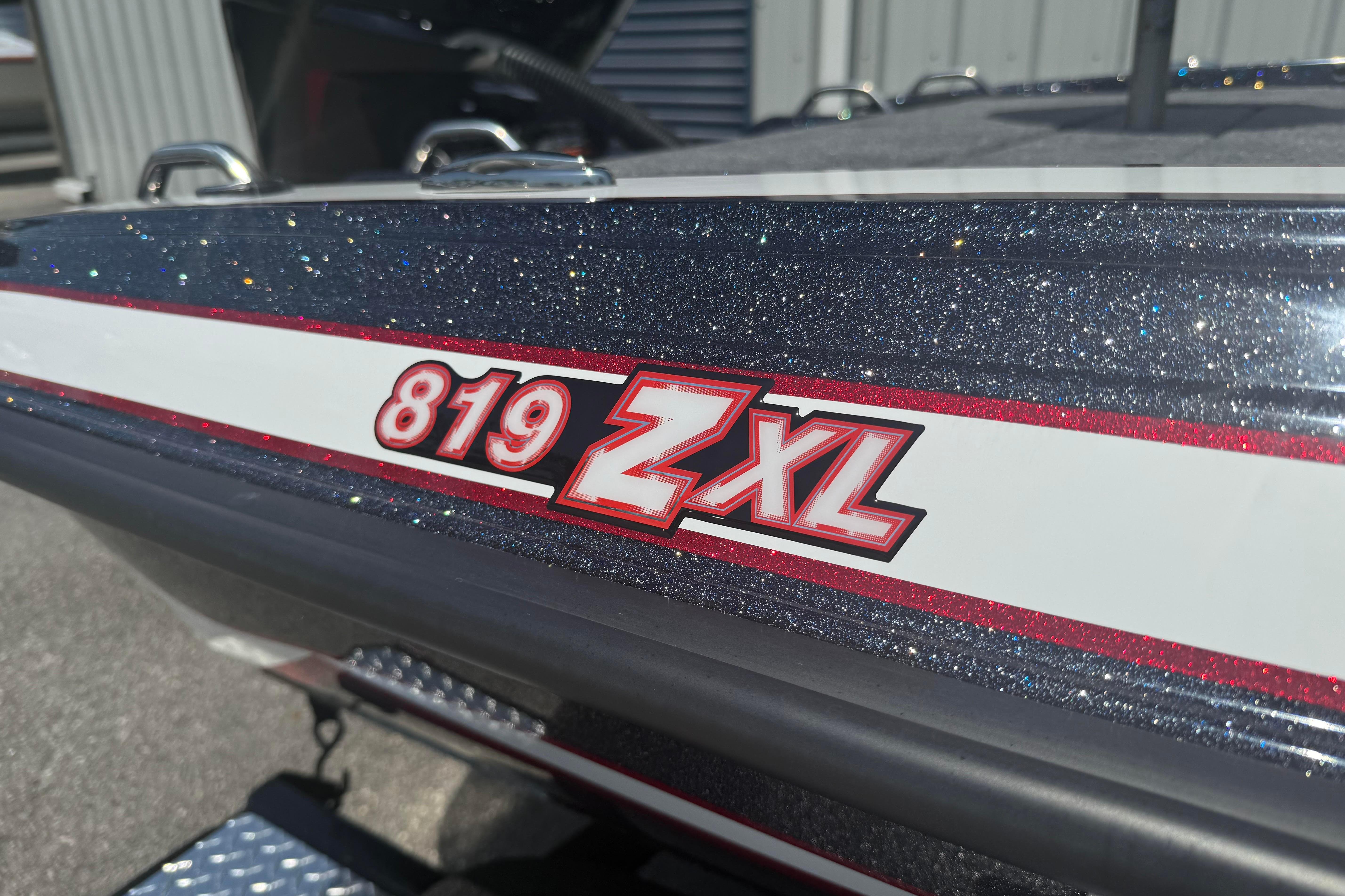 Close-up of 2027 Phoenix 819 ZXL boat model with glittery finish and bold red lettering.