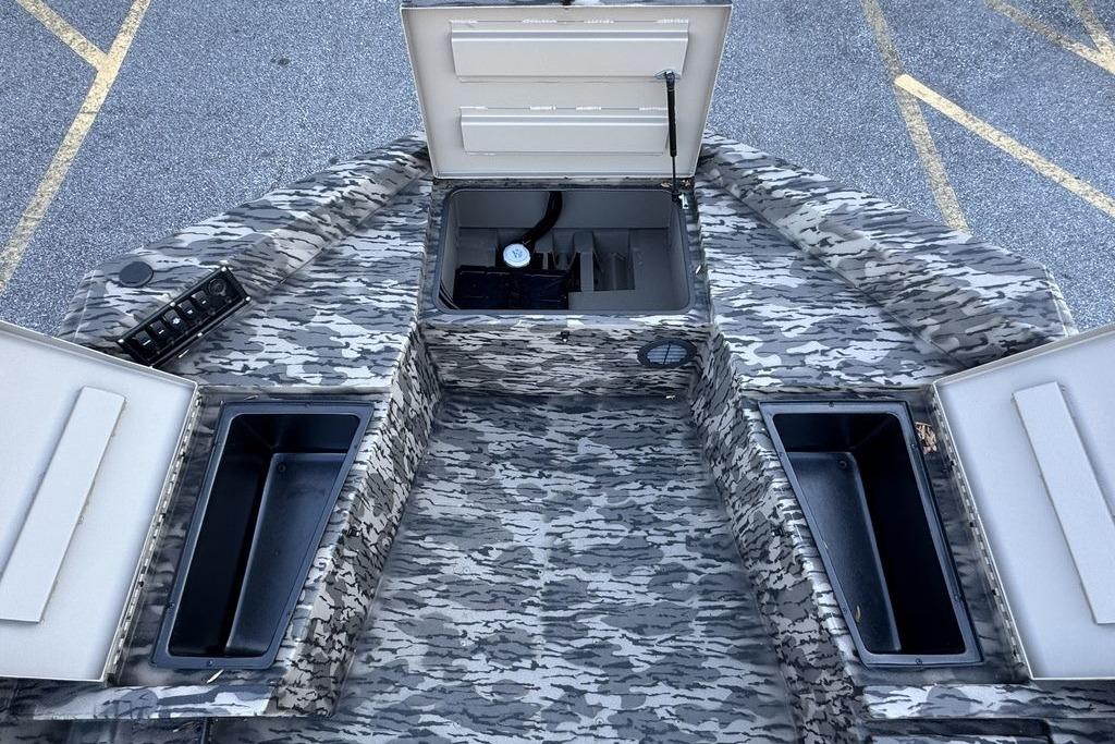 Camouflage interior of 2026 Havoc 1756 boat with open storage compartments.