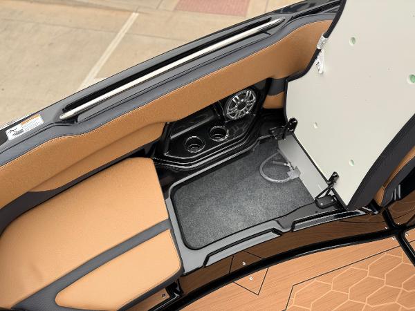 2025 Yamaha Boats 255XD interior with tan seating and built-in speaker system.