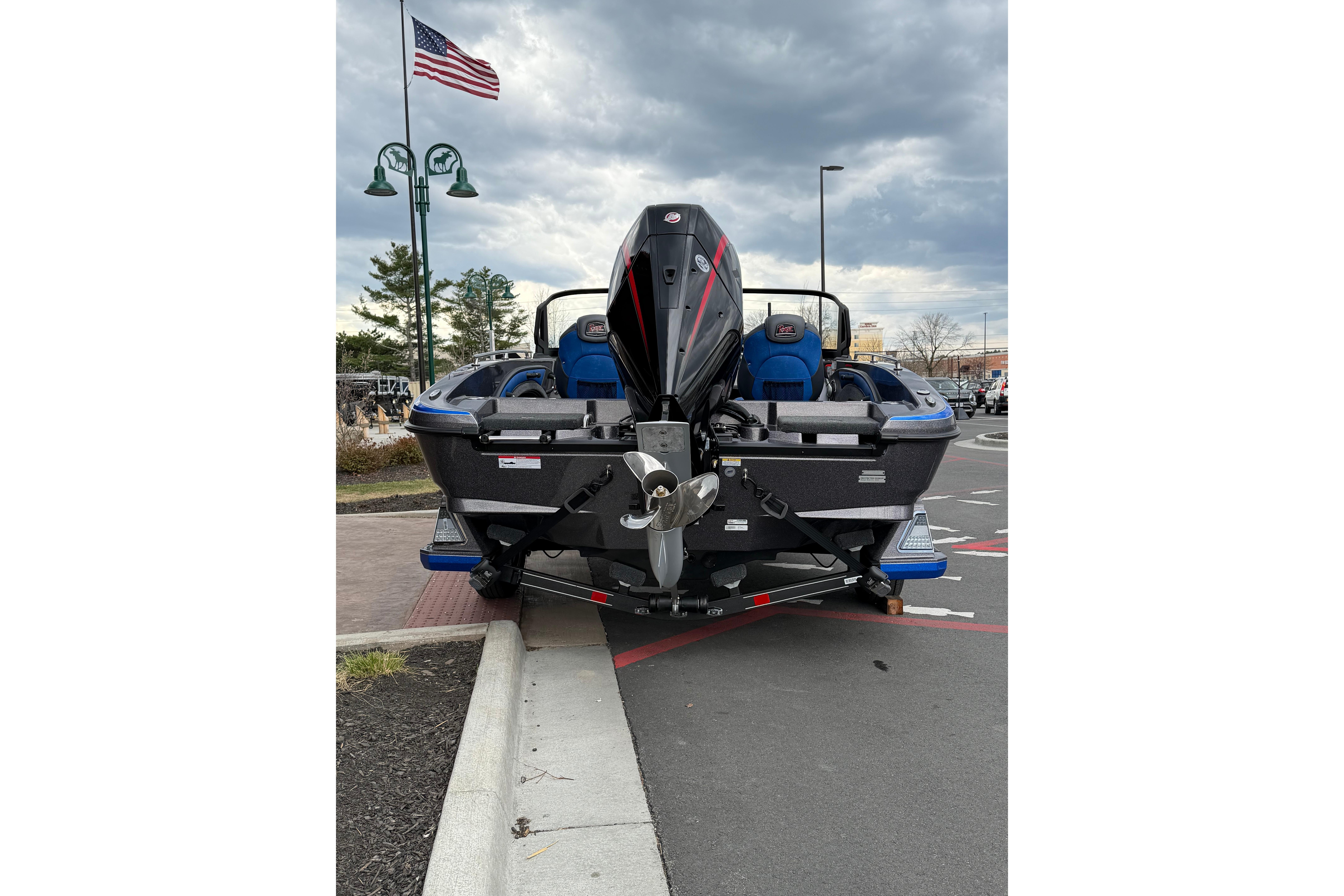 2026 Ranger 1880MS boat with powerful outboard motor, parked under cloudy sky.