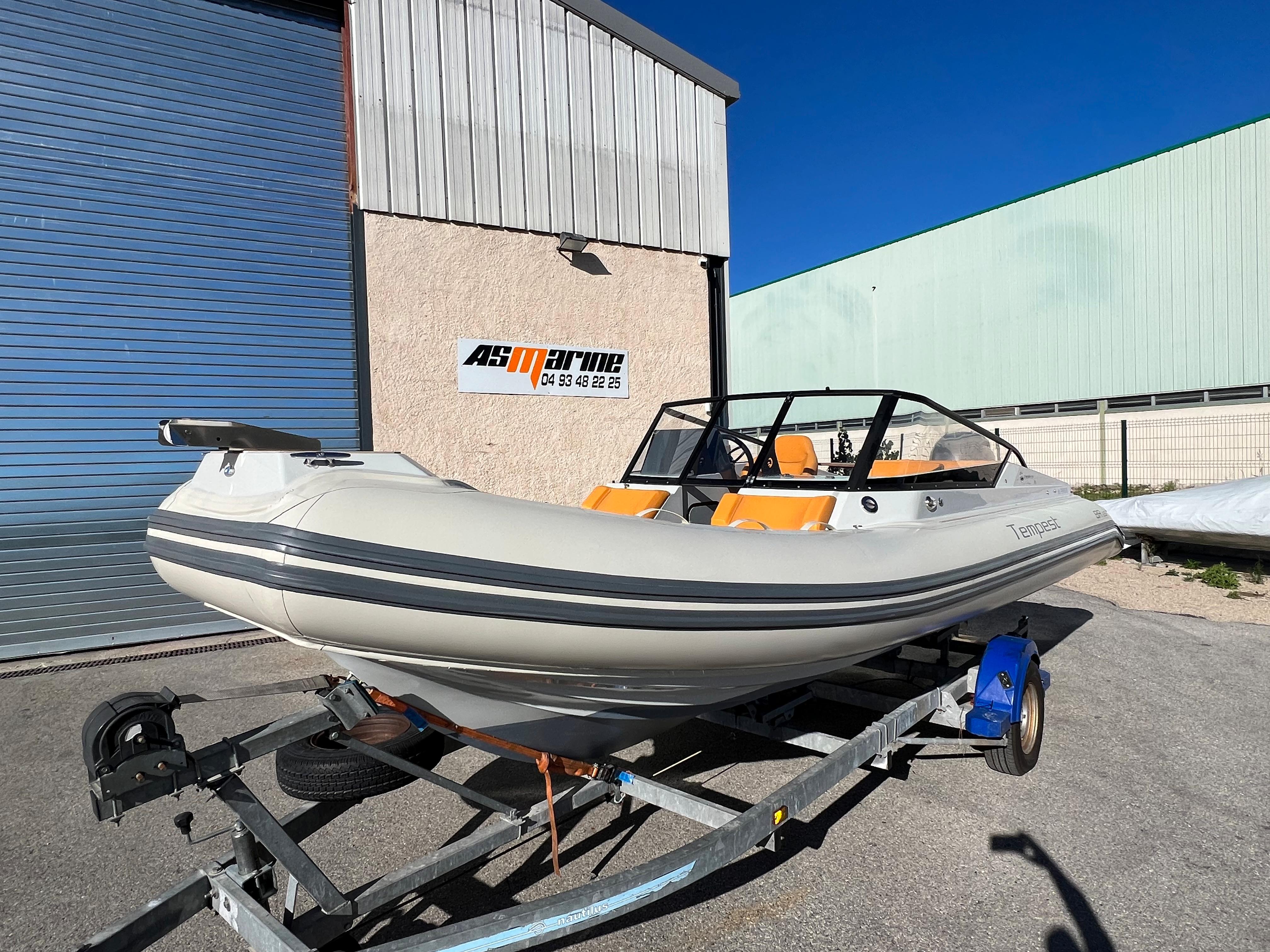2020 Capelli TEMPEST 650 BR boat on trailer, parked outside a building.